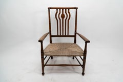 Liberty and Co. An Arts and Crafts rush seat armchair