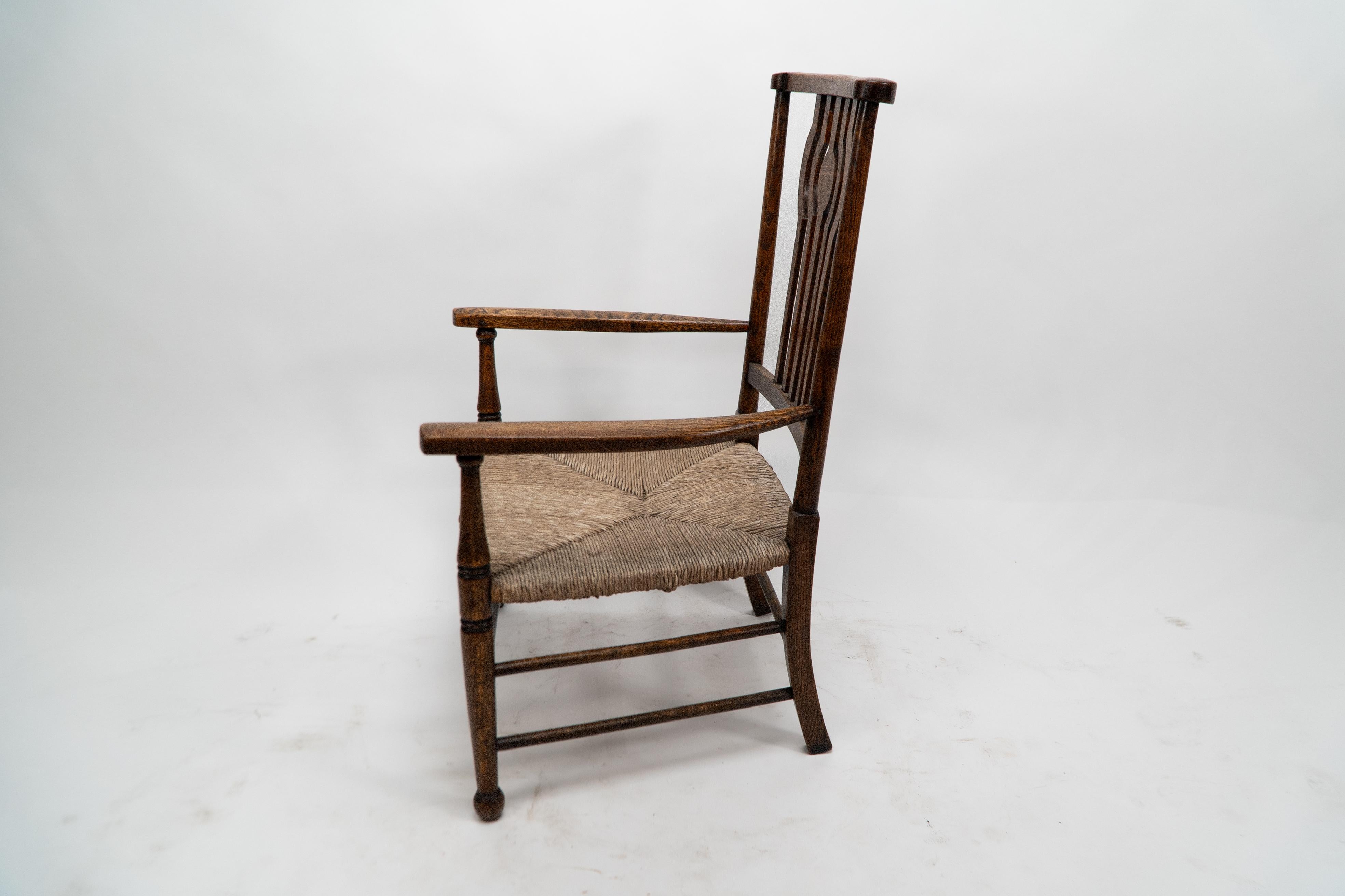 Liberty and Co. An Arts and Crafts rush seat armchair In Good Condition For Sale In London, GB
