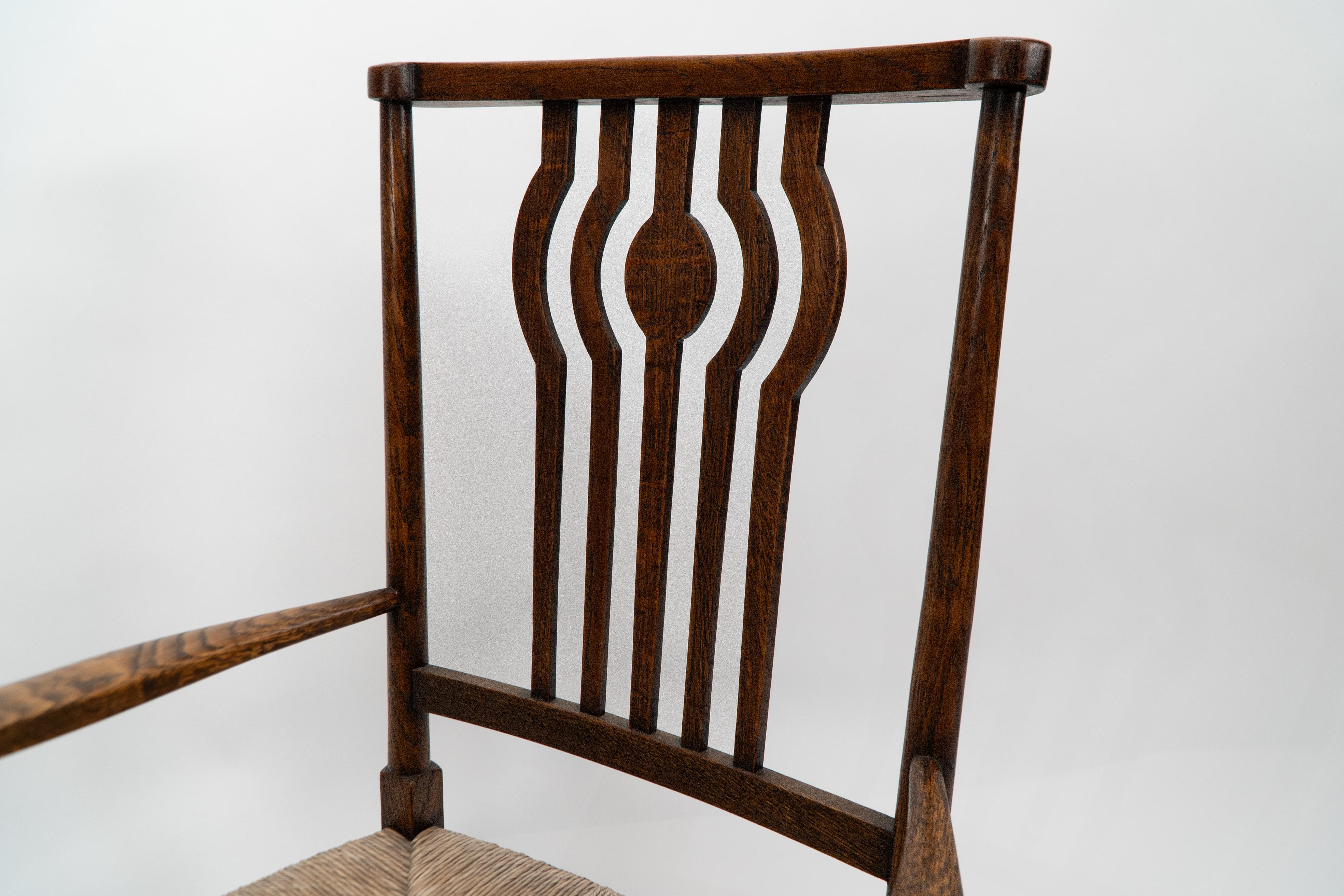 Liberty and Co. An Arts and Crafts rush seat armchair For Sale 1