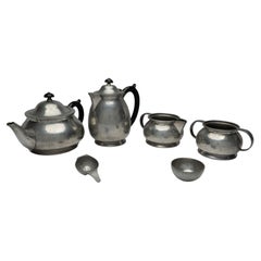 Antique Liberty and Co. An Arts and Crafts six piece pewter tudric tea set