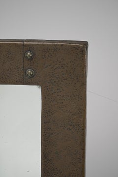 Liberty and Co. An Arts & Crafts copper mirror with a cloudy blue Ruskin Jewel