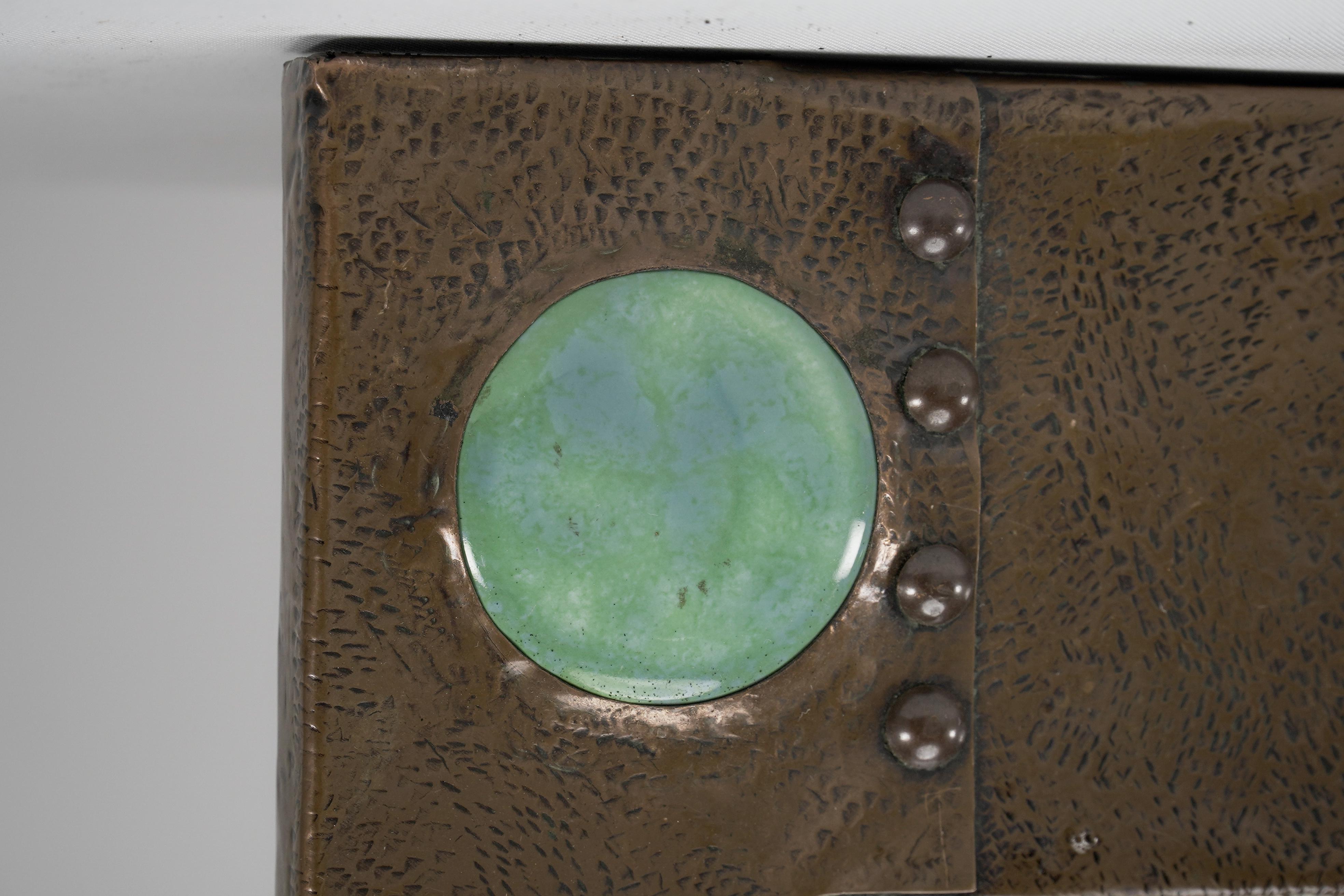 English Liberty and Co. An Arts & Crafts copper mirror with a cloudy blue Ruskin Jewel For Sale