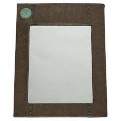 Liberty and Co. An Arts & Crafts copper mirror with a cloudy blue Ruskin Jewel