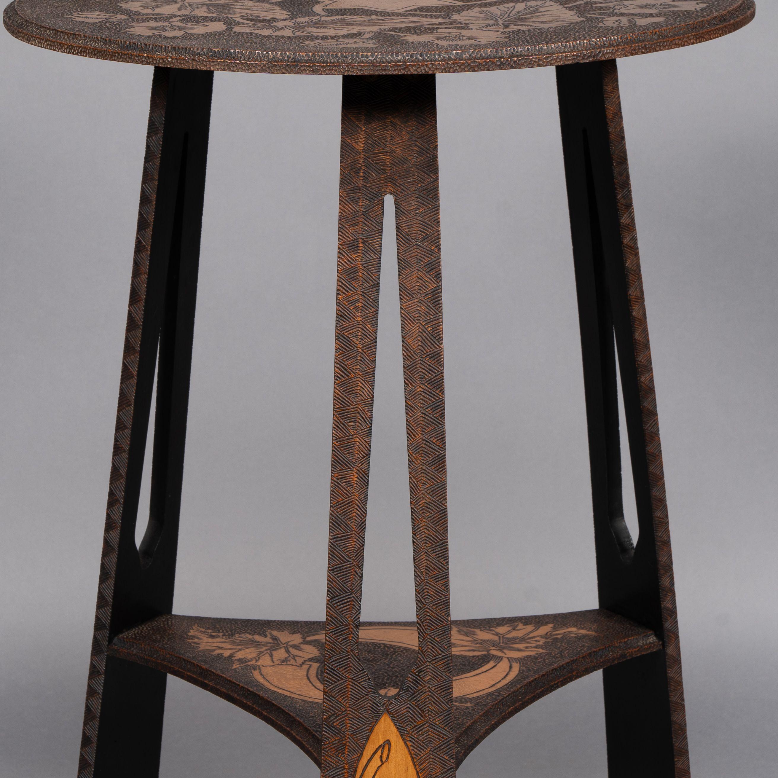 Liberty and Co. An intricately carved Arts and Crafts sidetable 4