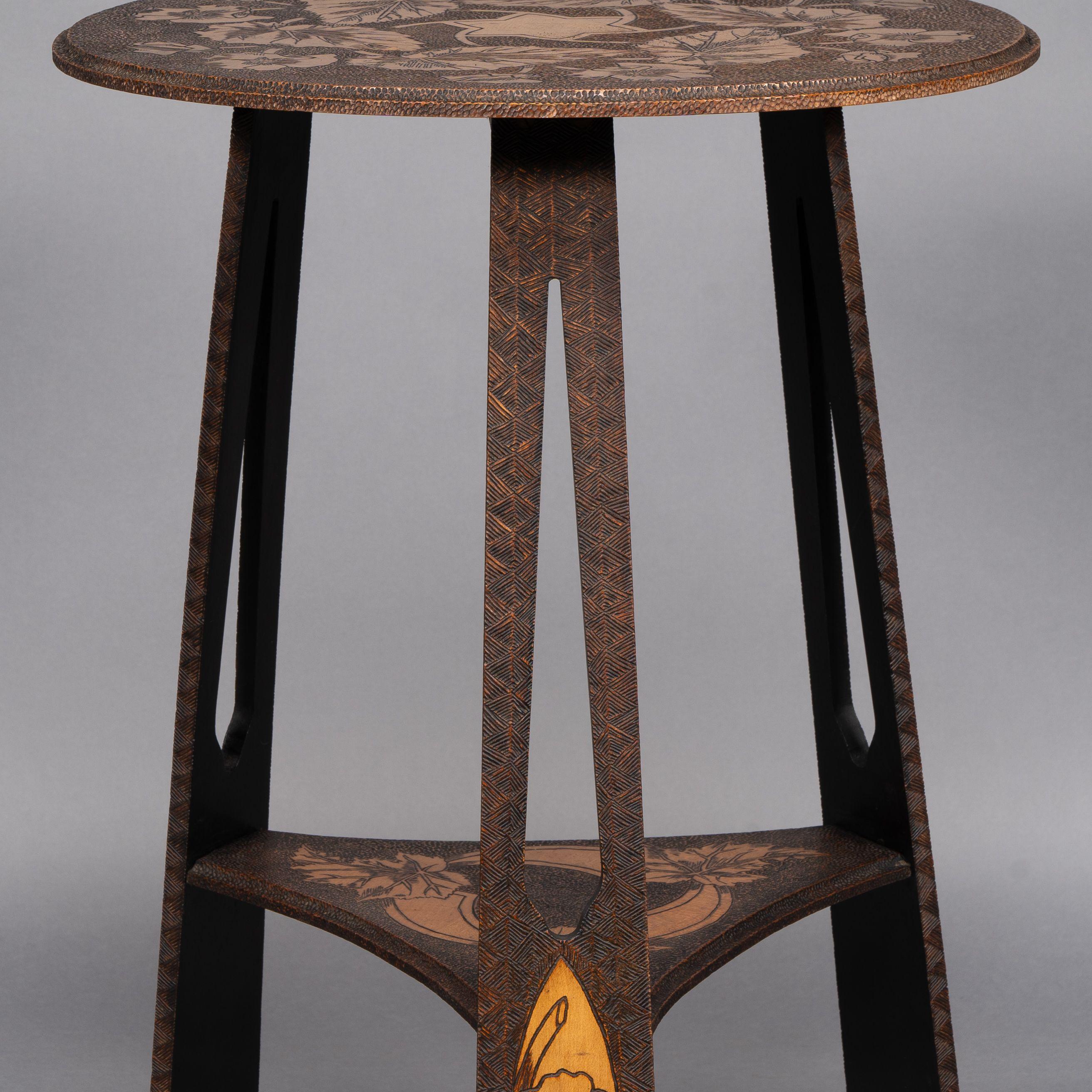 Liberty and Co. An intricately carved Arts and Crafts sidetable 5