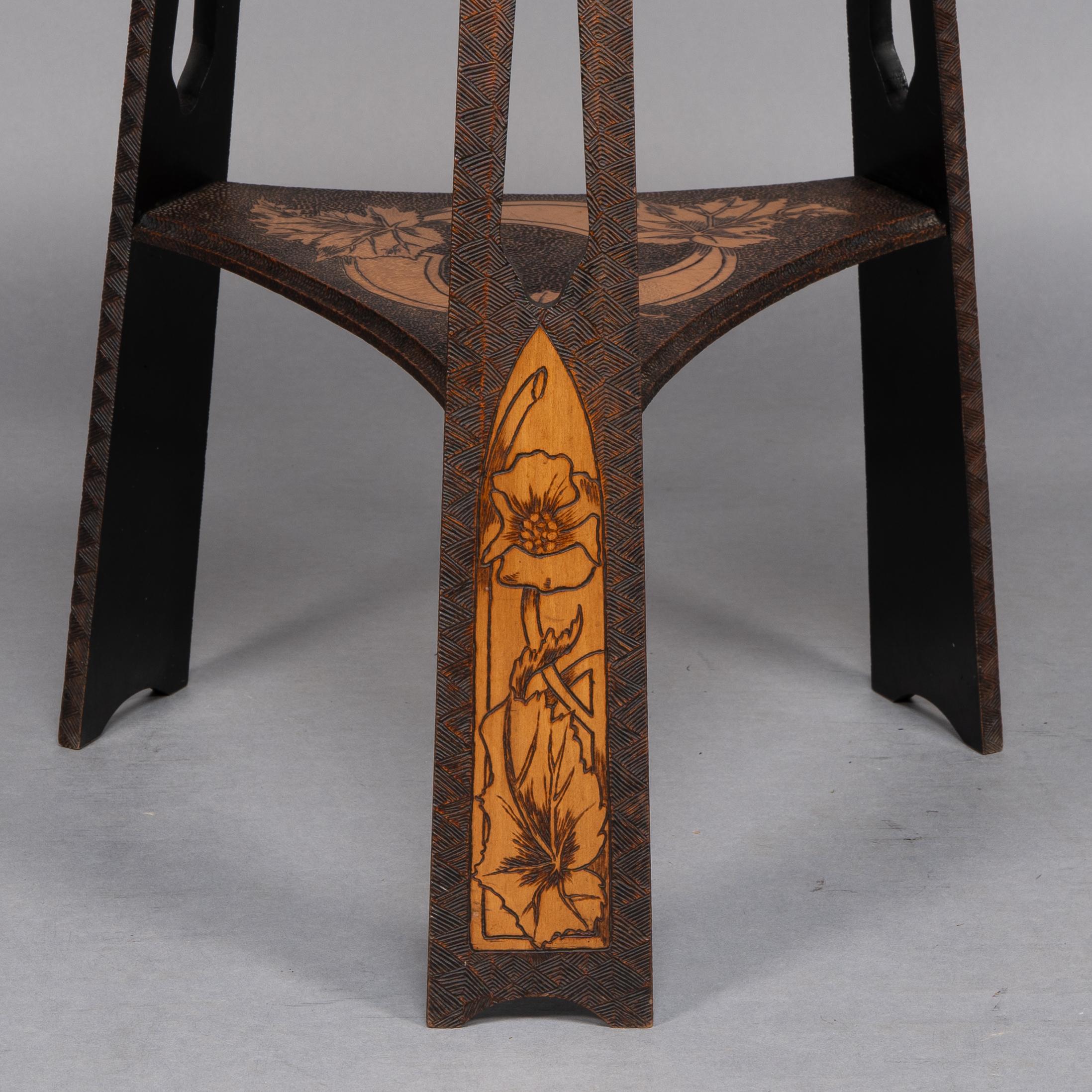 Liberty and Co. An intricately carved Arts and Crafts sidetable 8