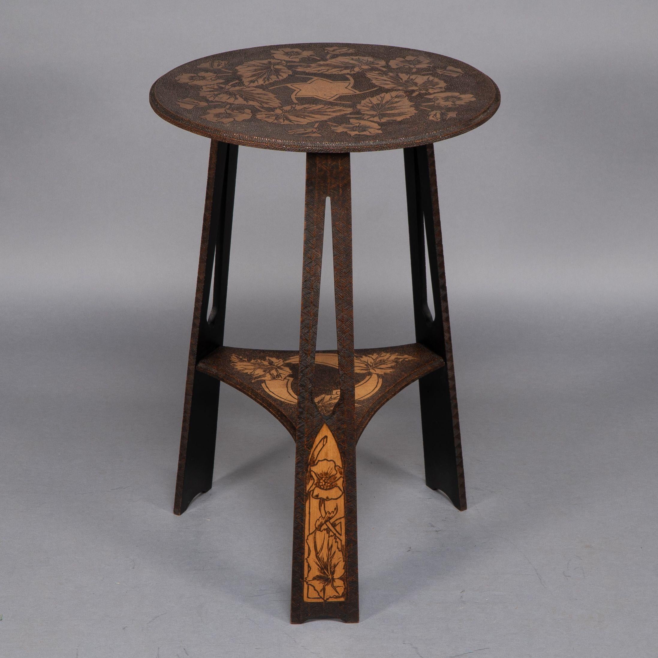 English Liberty and Co. An intricately carved Arts and Crafts sidetable