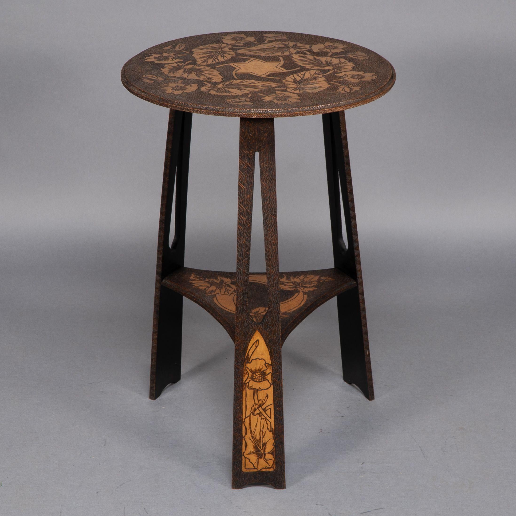 Early 20th Century Liberty and Co. An intricately carved Arts and Crafts sidetable