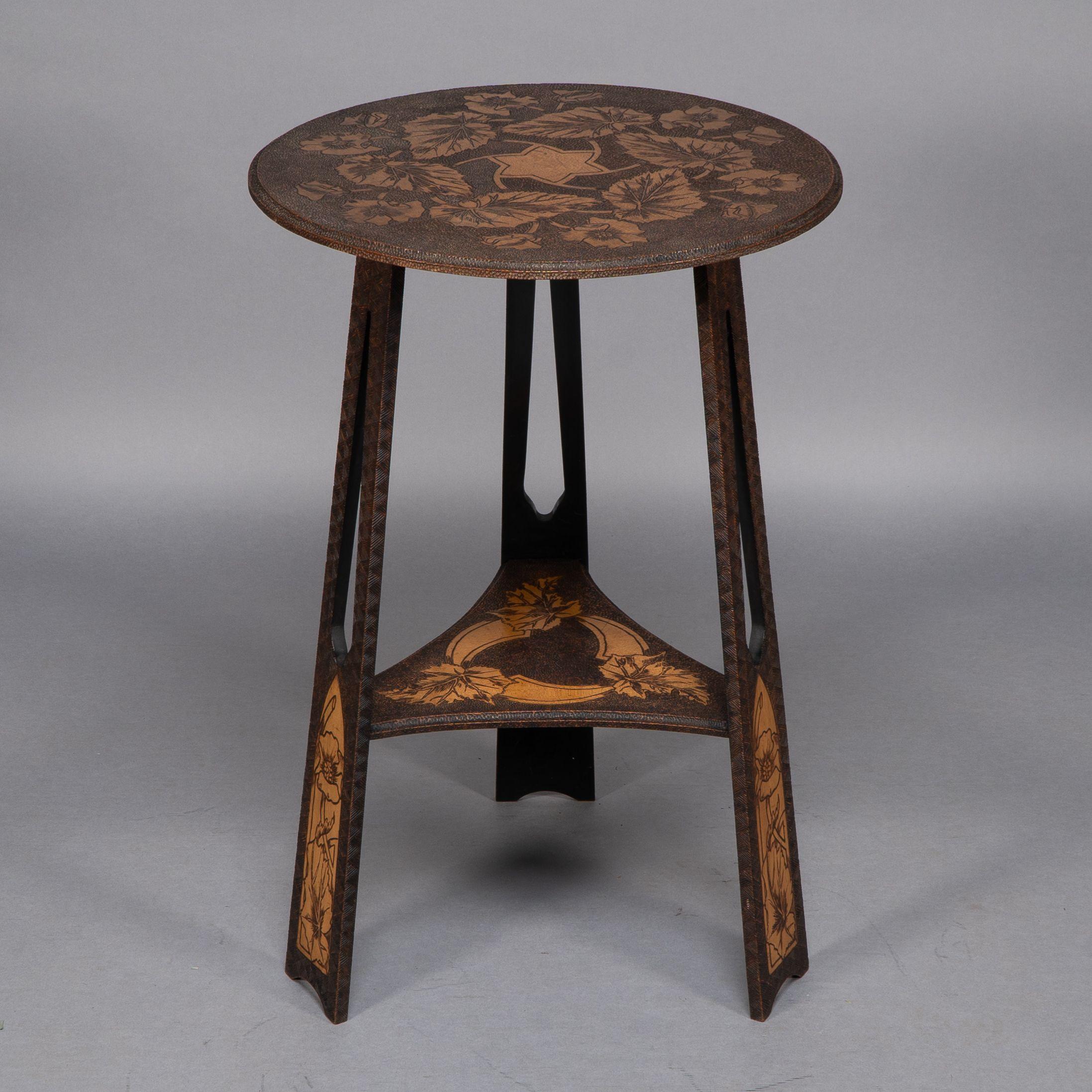 Walnut Liberty and Co. An intricately carved Arts and Crafts sidetable