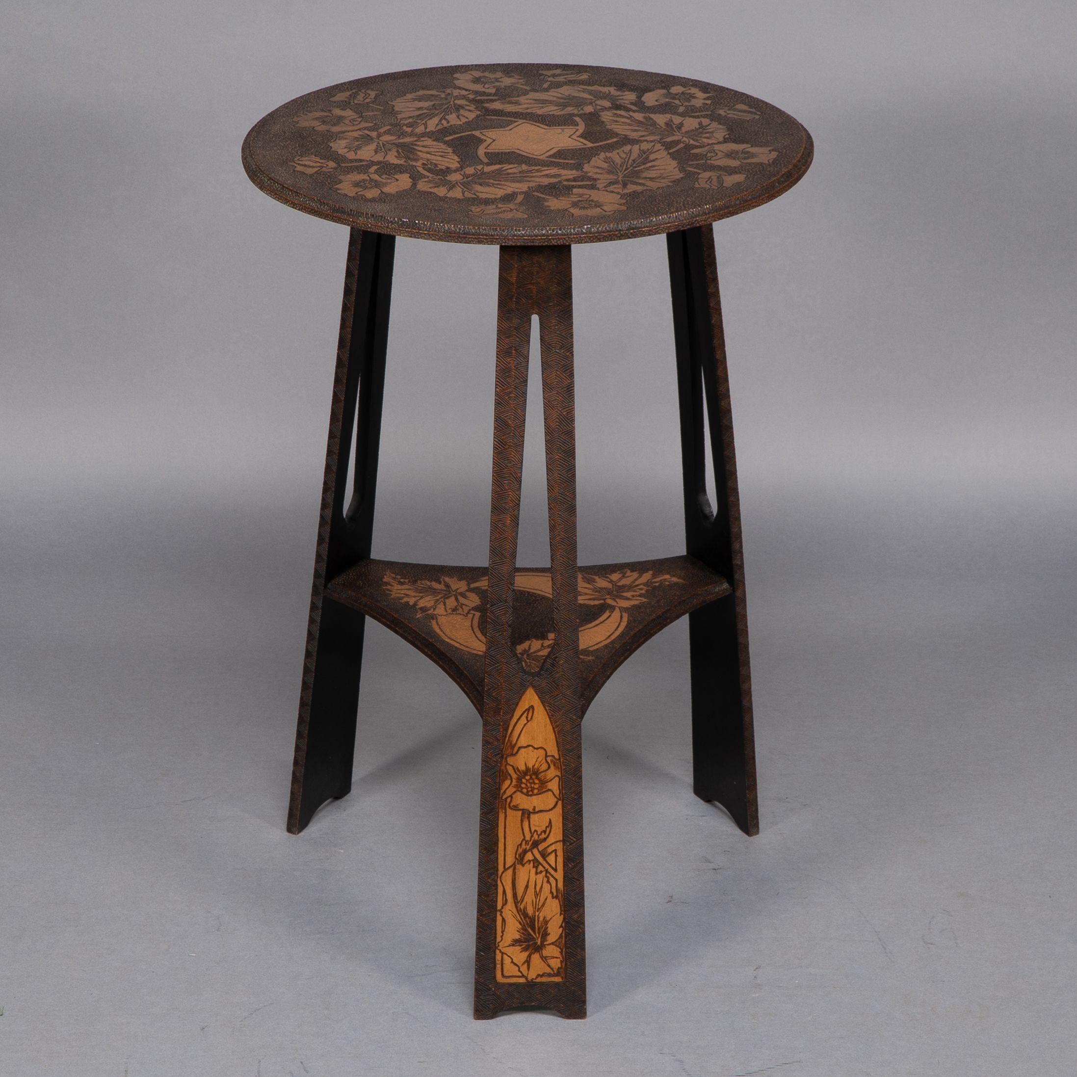 Liberty and Co. An intricately carved Arts and Crafts sidetable 1