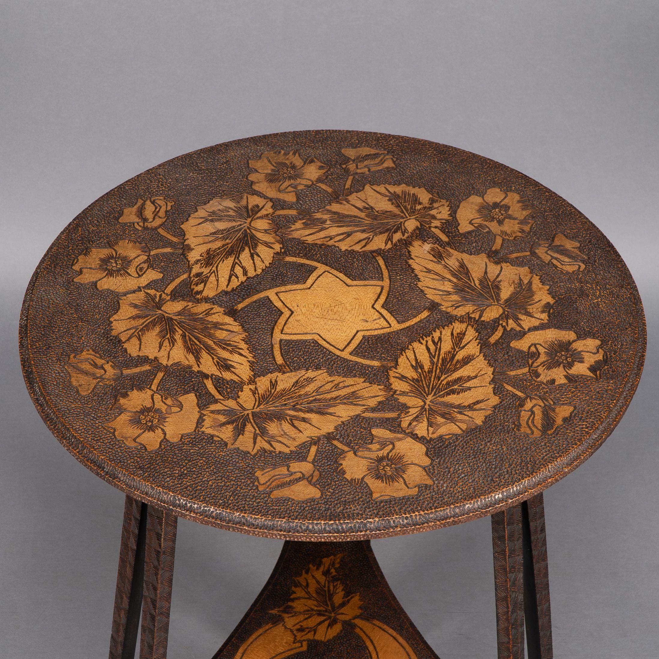 Liberty and Co. An intricately carved Arts and Crafts sidetable 3