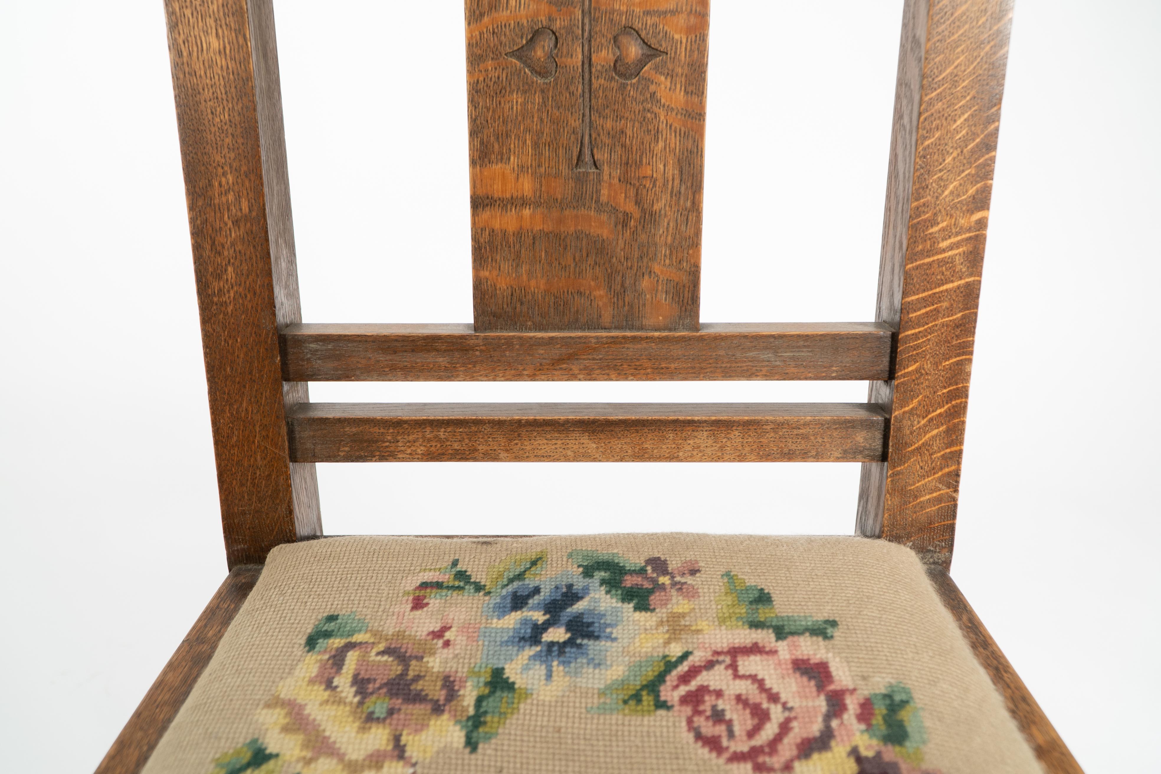 Liberty & Co. An Arts & Crafts oak chair with carved rose decoration to the back For Sale 4