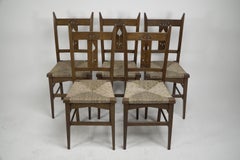 Liberty & Co attributed. Set of six Glasgow Style oak & rush seat dining chairs.