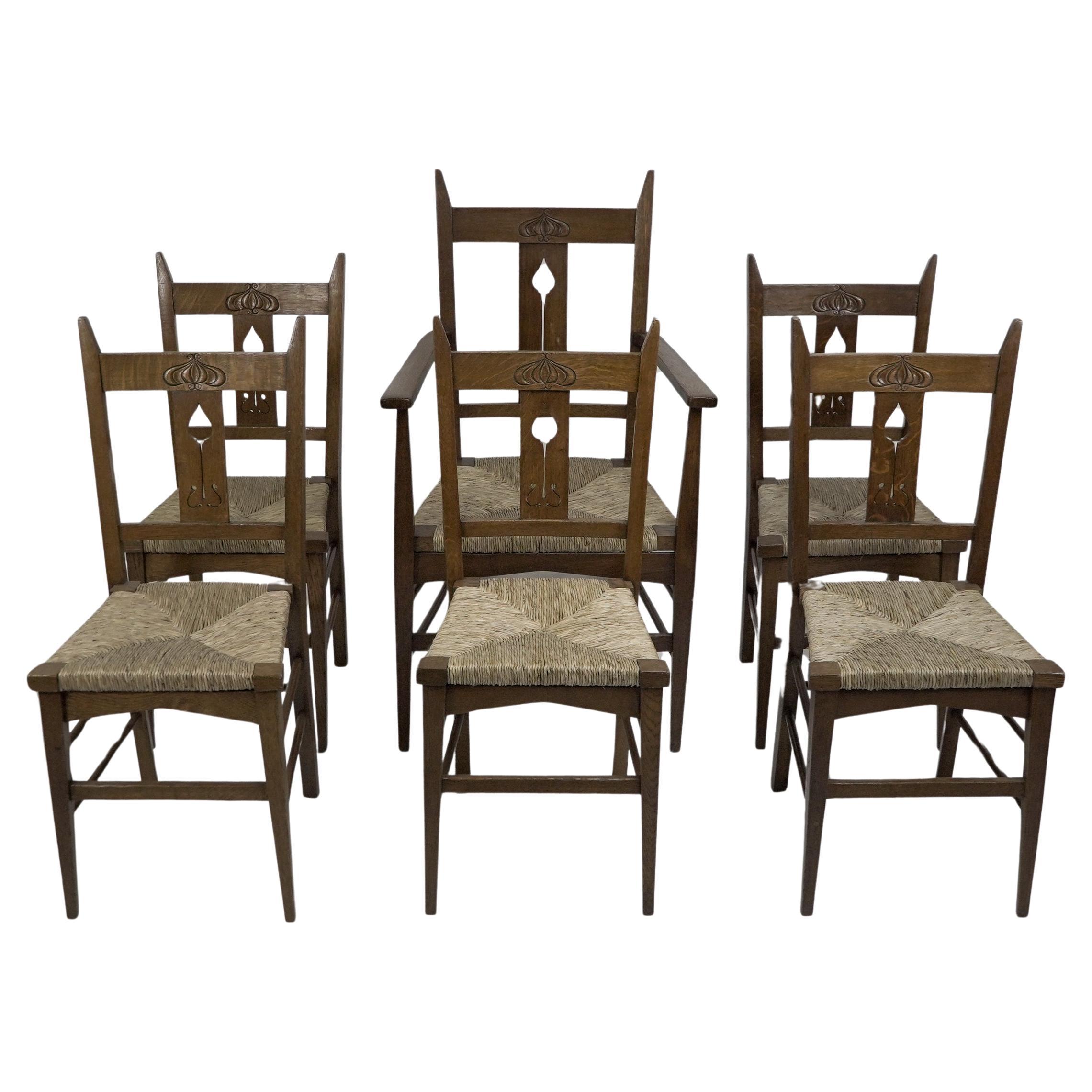 Liberty & Co attributed. Set of six Glasgow Style oak & rush seat dining chairs.