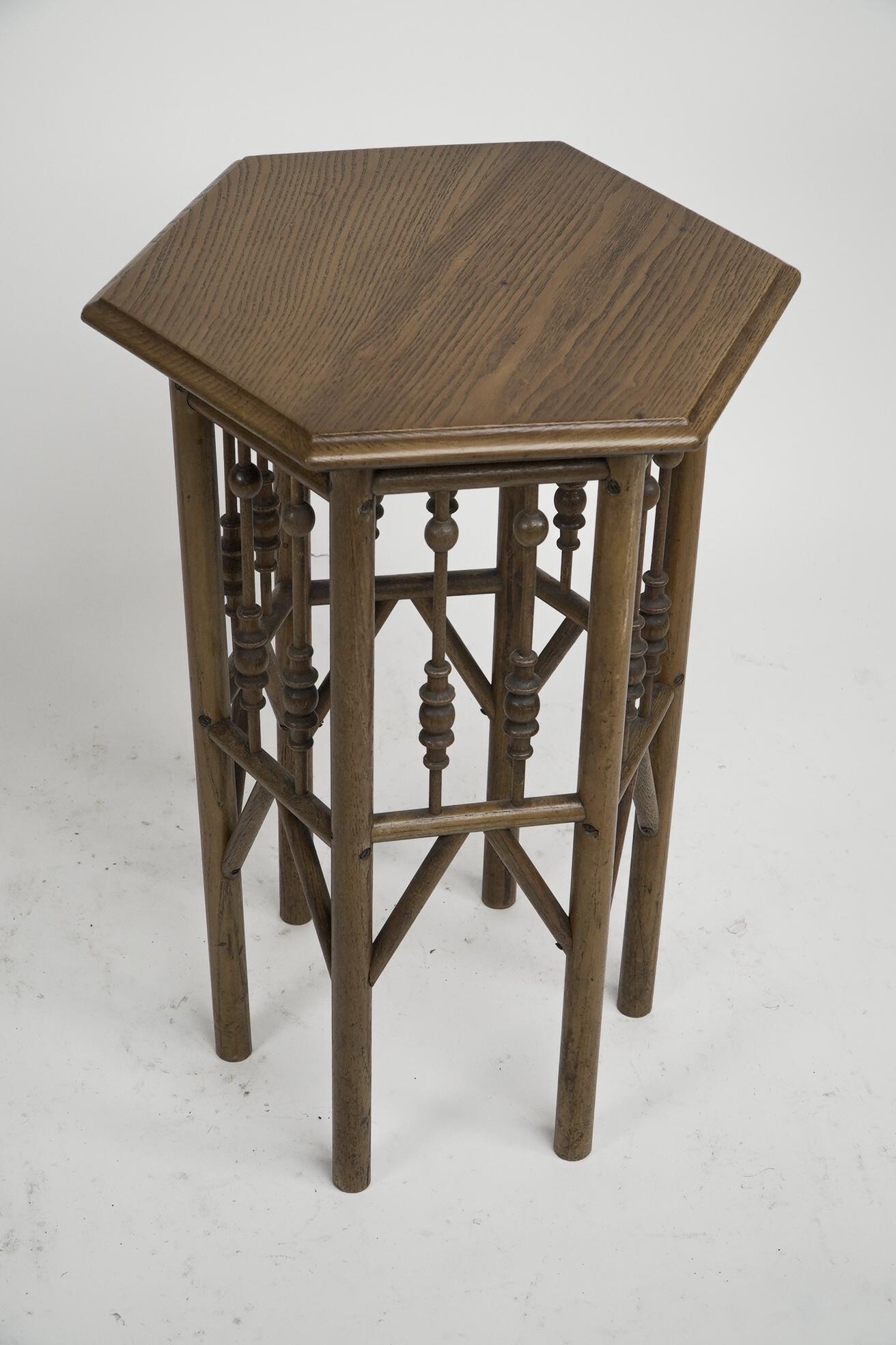 Liberty and Co attributed. 
A small Moorish Hexagon oak side table with elongated bobbin style turnings to each side and Thebes style lower supports.