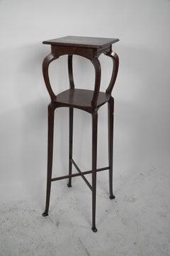 Liberty & Co attr A Tall Arts & Crafts Walnut torchère with an Art Nouveau style