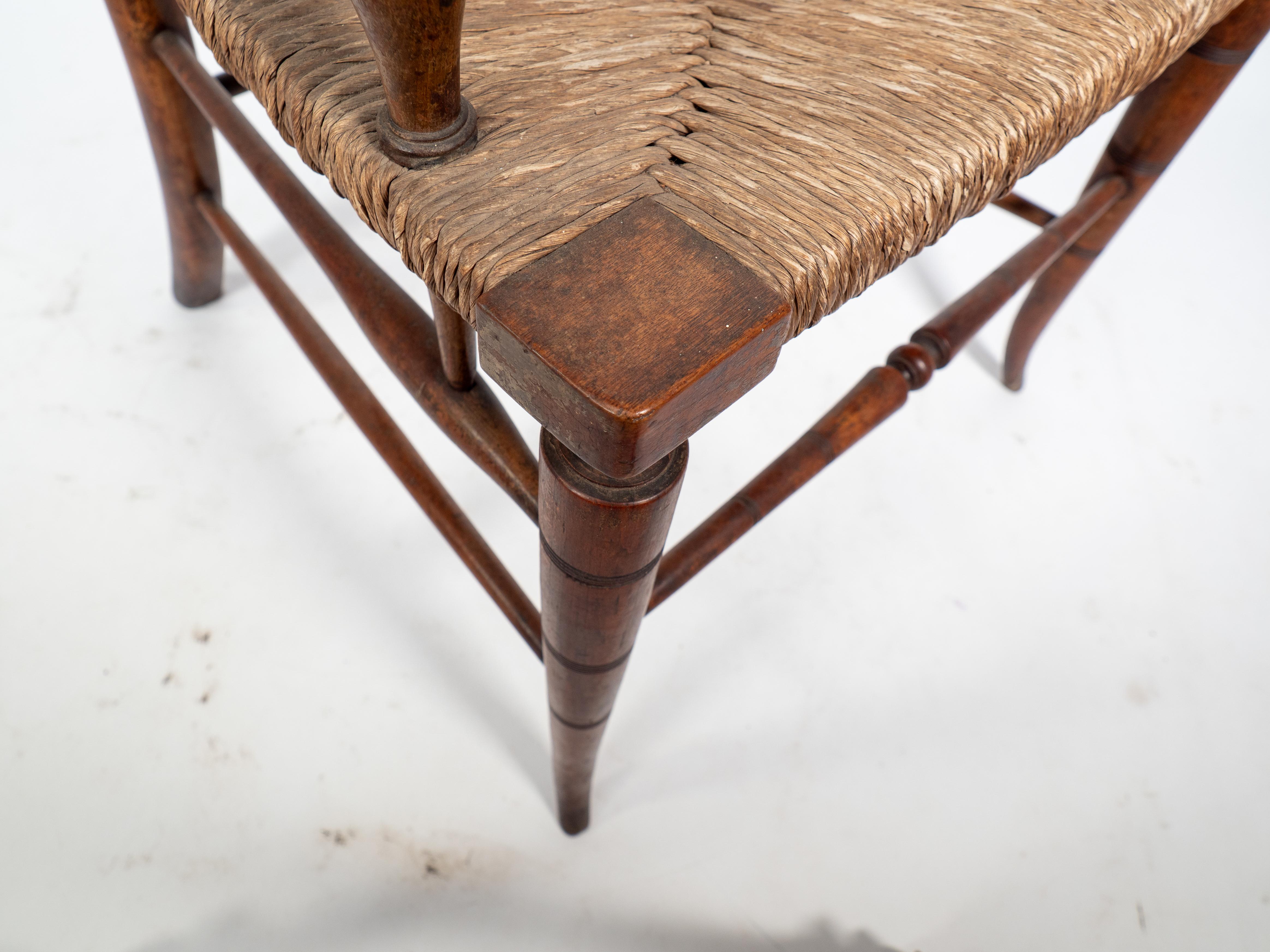Beech Liberty and Co attributed An Aesthetic Movement rush seat armchair For Sale