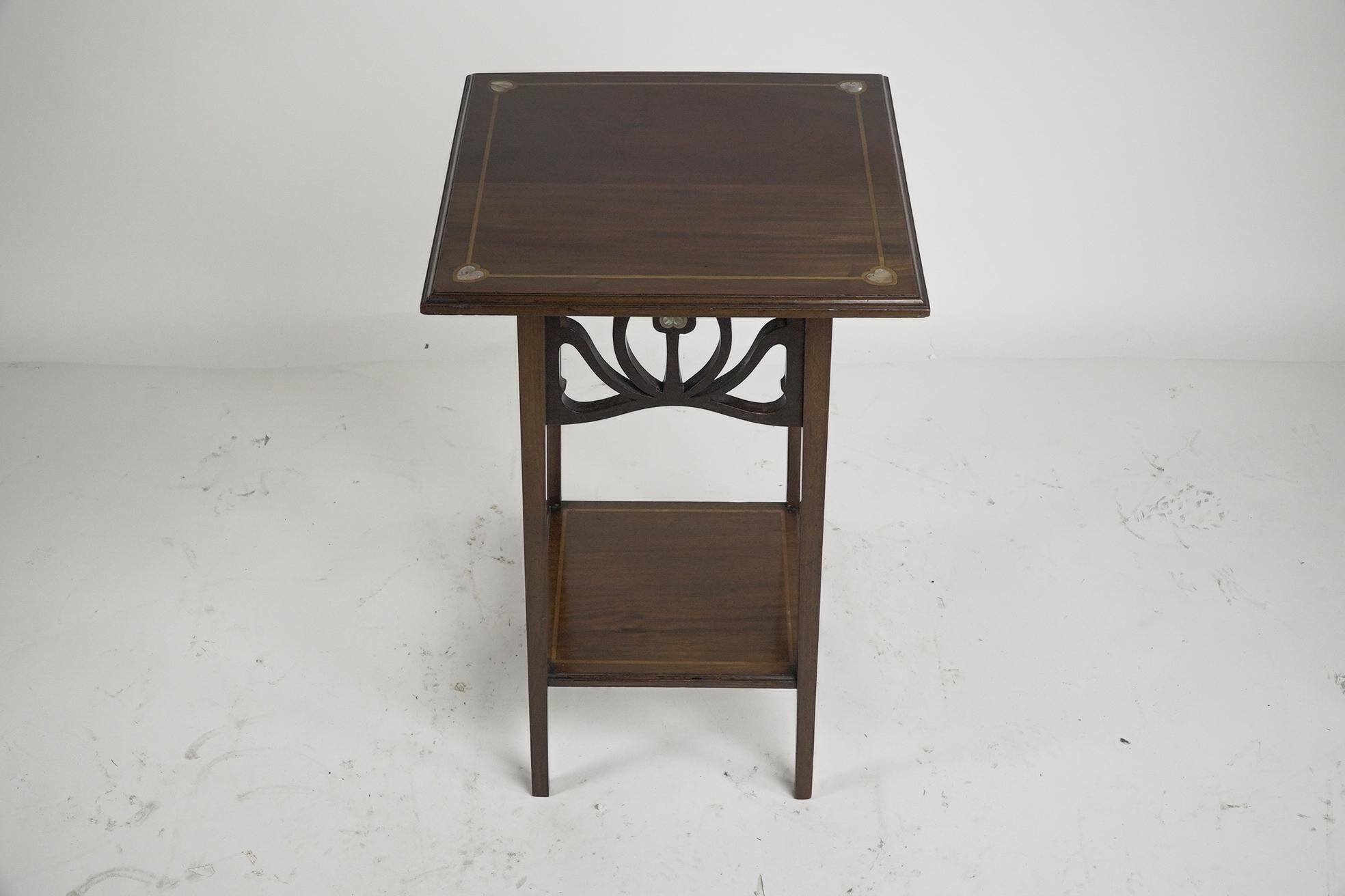 English Liberty and Co (attributed). A mahogany occasional table with Mother-Of-Pearl For Sale