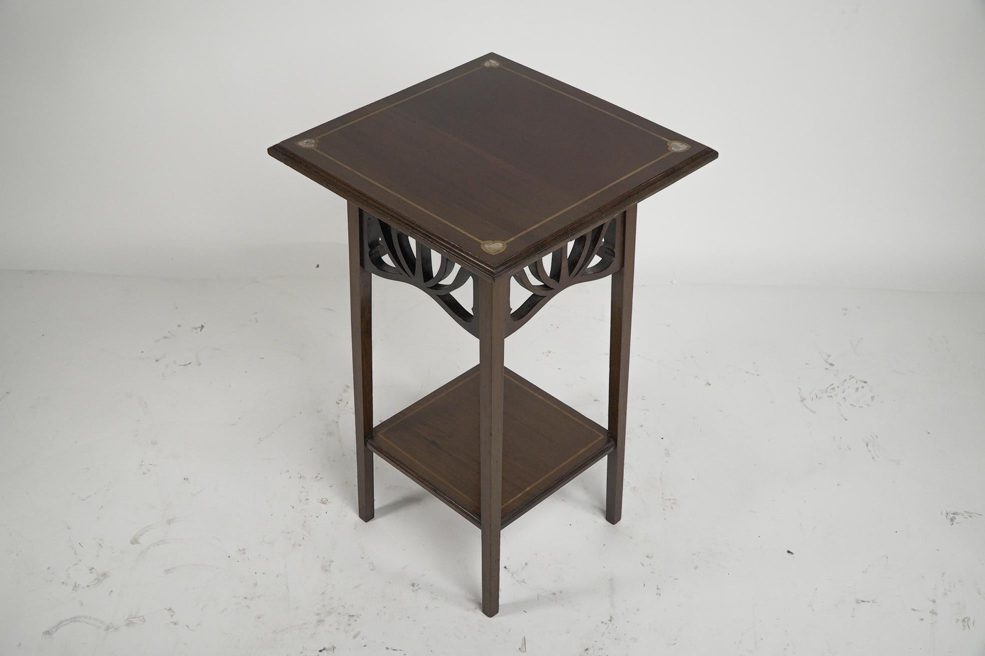 Early 20th Century Liberty and Co (attributed). A mahogany occasional table with Mother-Of-Pearl For Sale