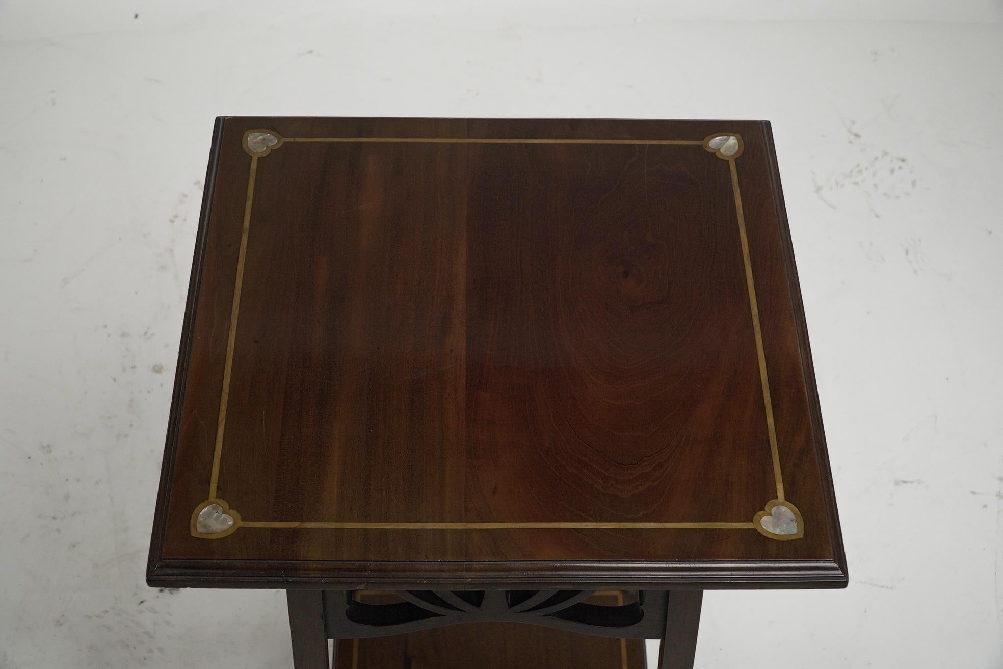 Mahogany Liberty and Co (attributed). A mahogany occasional table with Mother-Of-Pearl For Sale