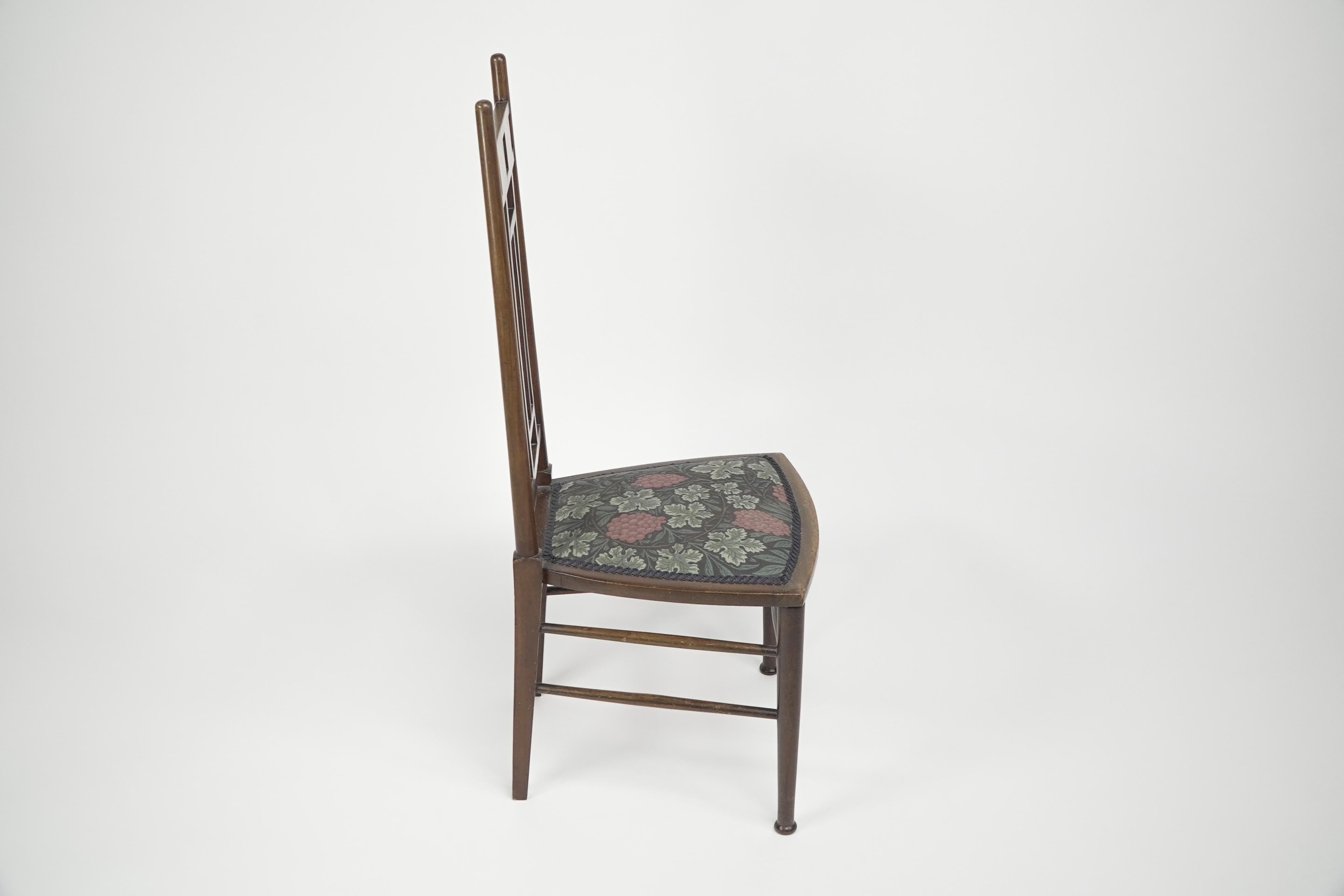 English E G Punnett for Liberty & Co. A Walnut side chair with inlaid floral decoration. For Sale