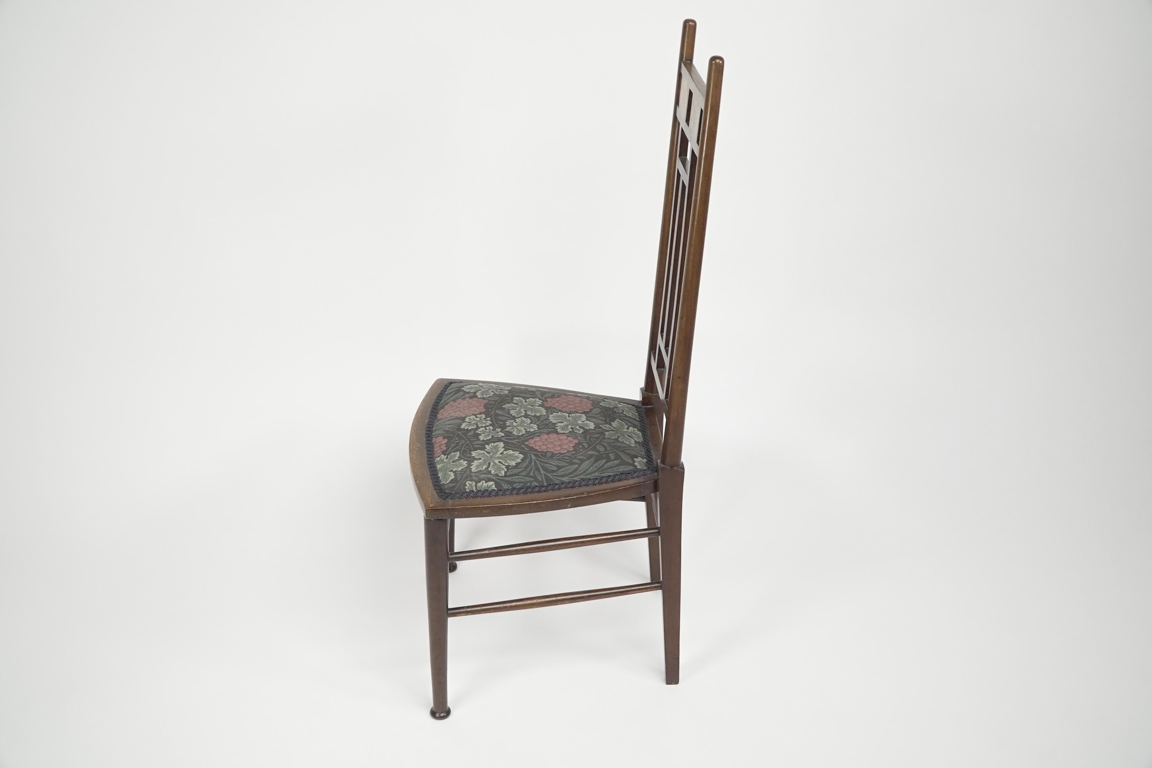 E G Punnett for Liberty & Co. A Walnut side chair with inlaid floral decoration. In Good Condition For Sale In London, GB