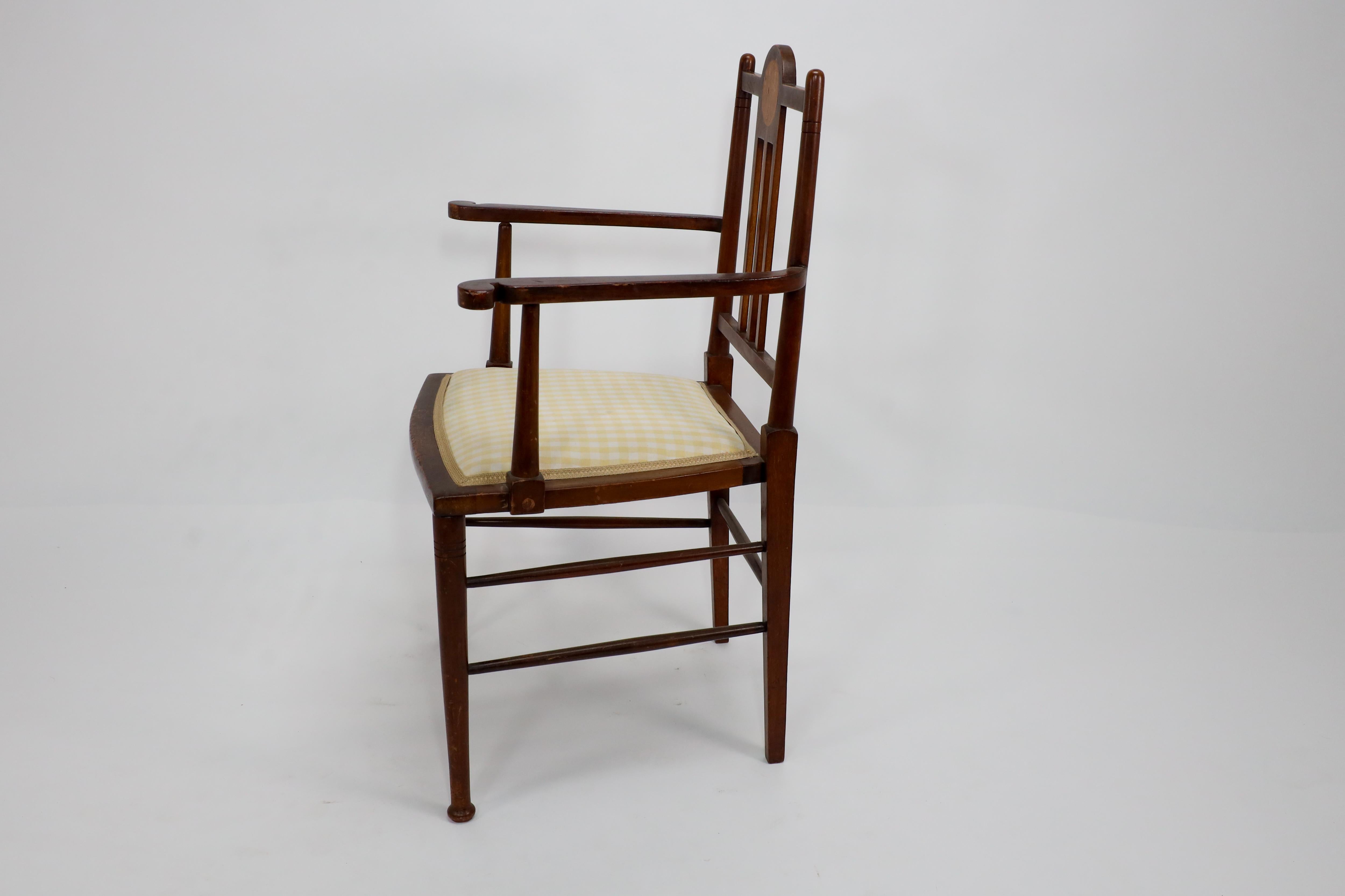 English Liberty and Co in the style of G M Ellwood. An Arts and Crafts Walnut armchair For Sale