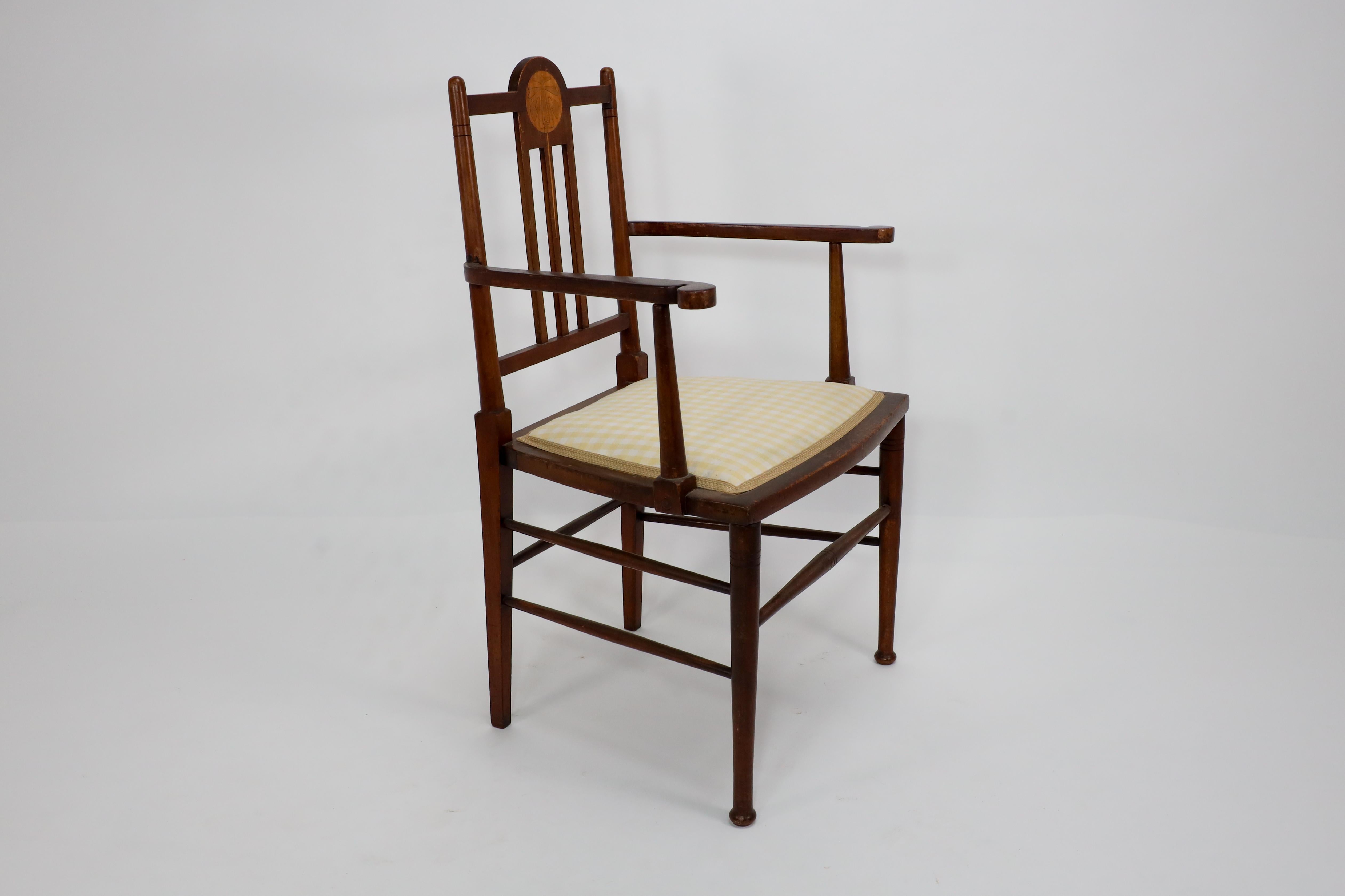 Liberty and Co in the style of G M Ellwood. An Arts and Crafts Walnut armchair For Sale 1