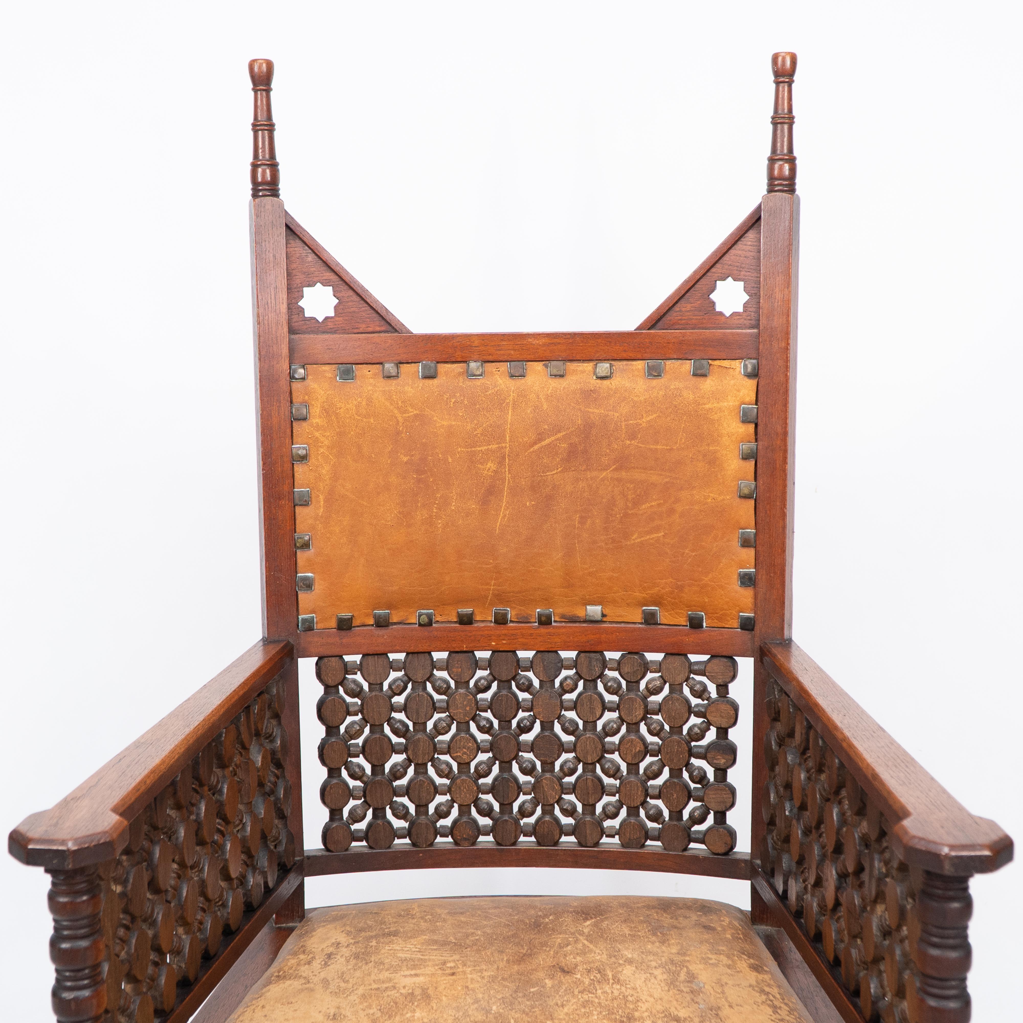 Leather Liberty & Co. A Moorish Arts & Crafts walnut armchair with original leather seat For Sale
