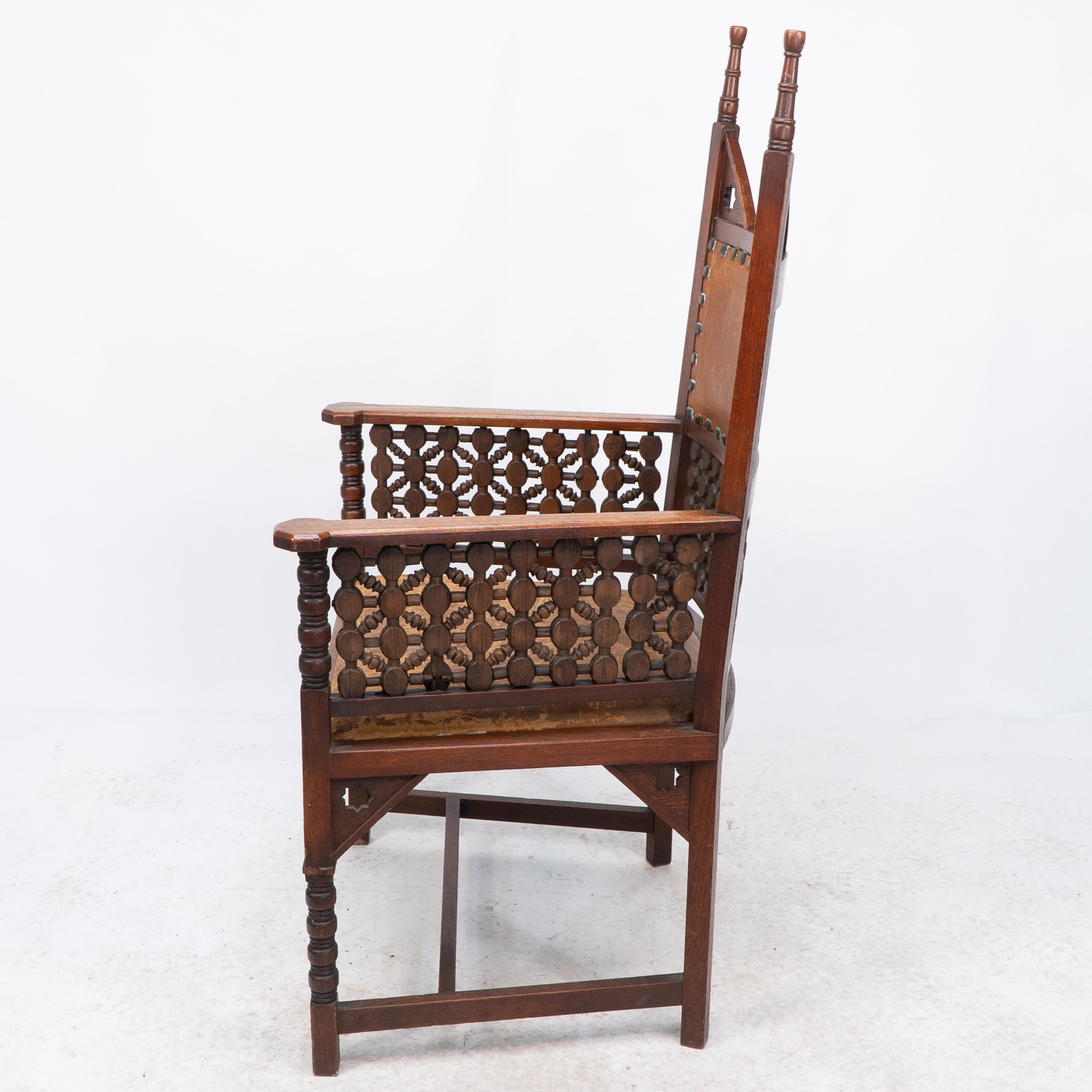 English Liberty & Co. A Moorish Arts & Crafts walnut armchair with original leather seat For Sale