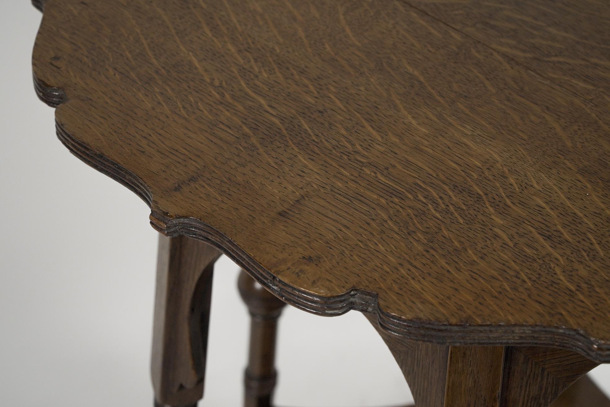 English Liberty and Co. Oak side or occasional table with a shaped top and molded edges