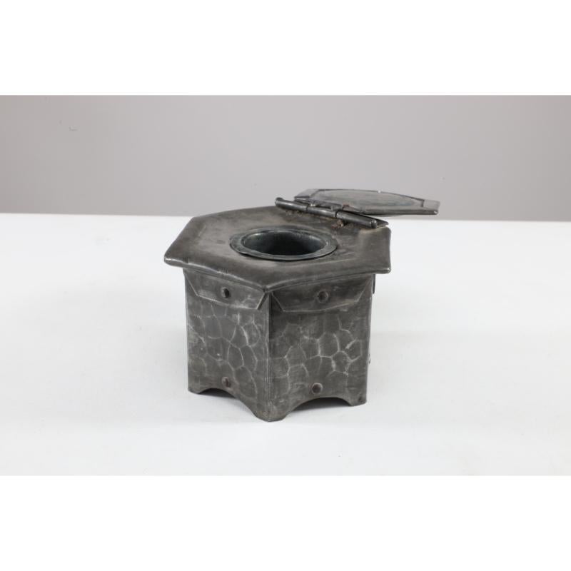 Liberty & Co in the style of. An English Arts & Crafts hexagonal pewter Inkwell with a Green Ruskin ceramic jewel to the hinged lid. Retaining the original pewter removable inkwell. Hand-made and hand-hammered with rivetted construction to each of