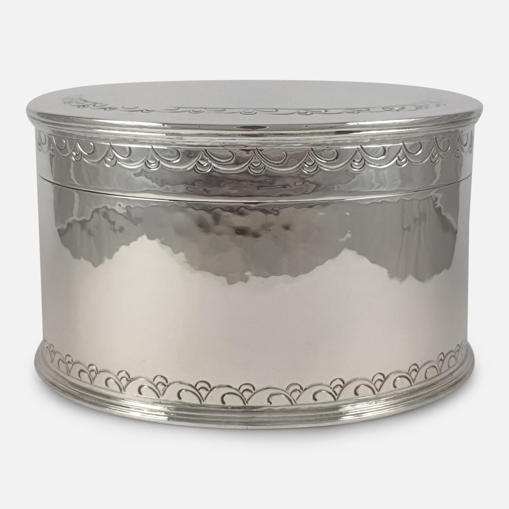 A George V sterling silver biscuit box by Liberty & Co. The biscuit box is of circular form, with hinged cover, punched borders, and spot-hammered decoration. The box is hallmarked with the makers mark of Liberty & Co Ltd, Birmingham, 1929.

Assay: