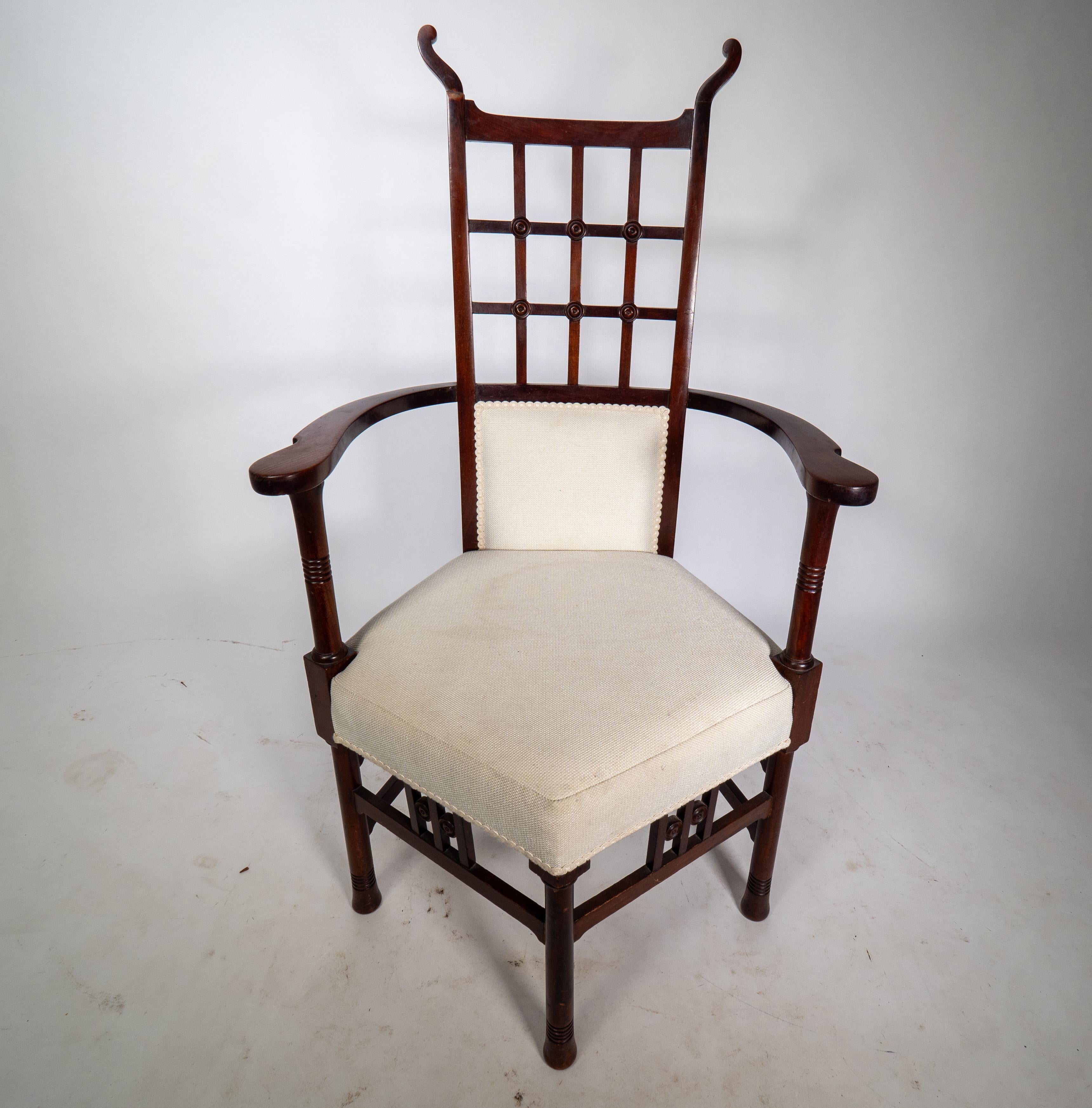English Liberty & Co probably made by William Birch. An Arts & Crafts mahogany armchair. For Sale