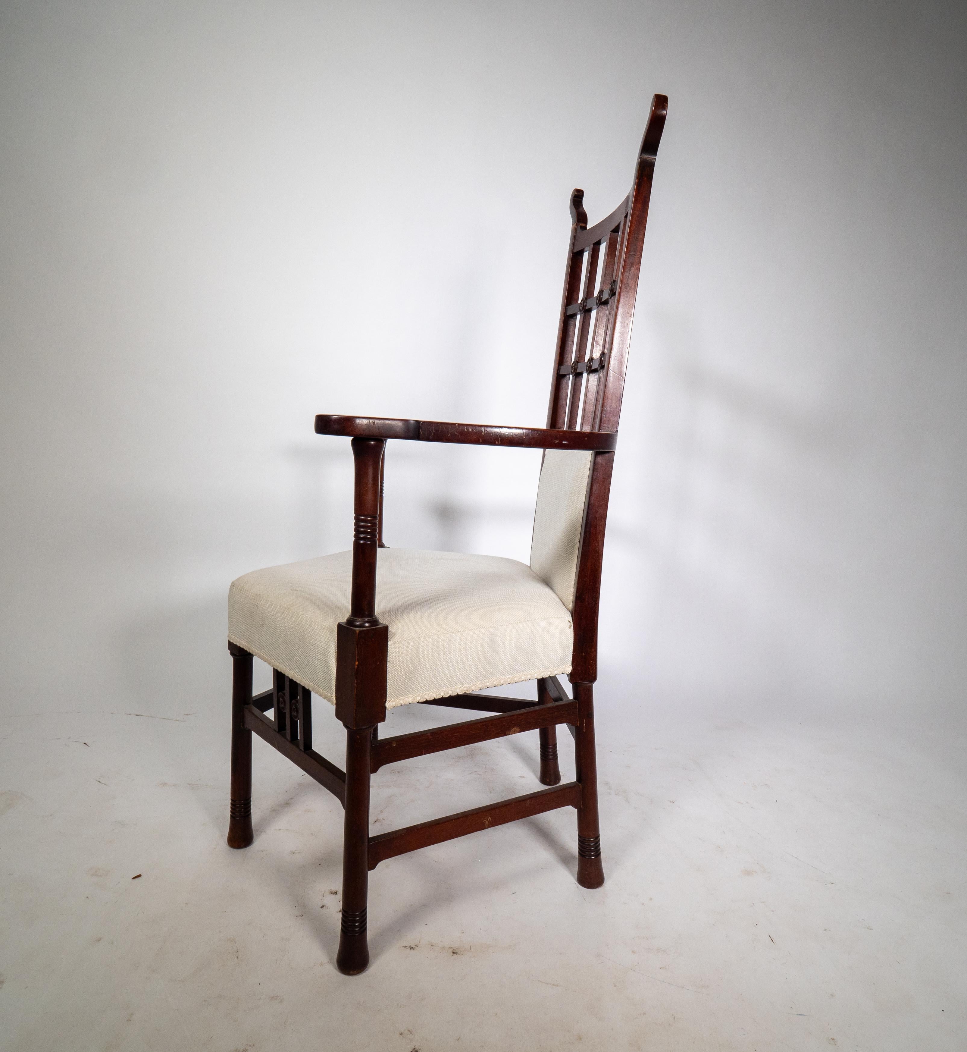 Early 20th Century Liberty & Co probably made by William Birch. An Arts & Crafts mahogany armchair. For Sale