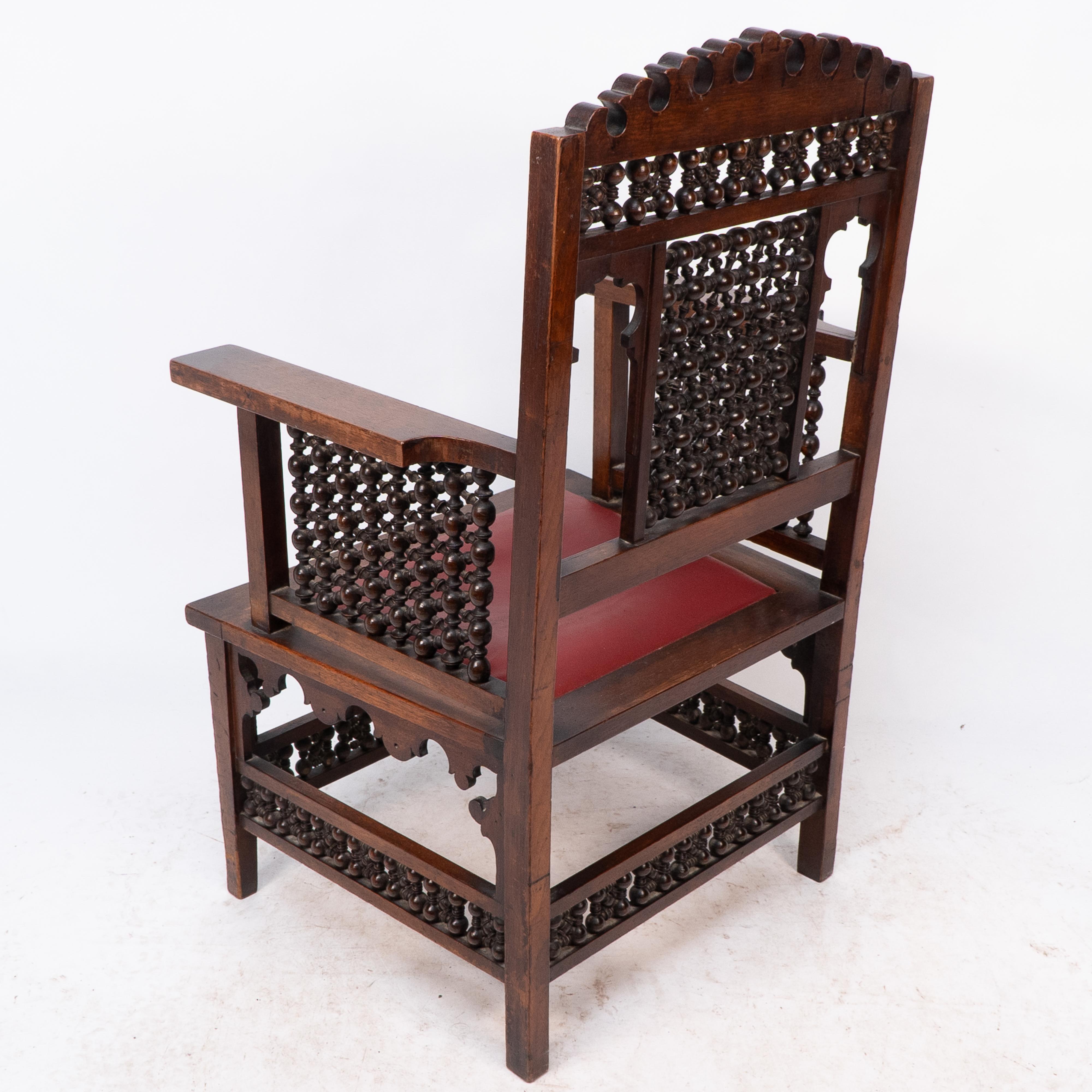 Liberty & Co A Moorish walnut armchair with Mashrabiya turned details throughout For Sale 10