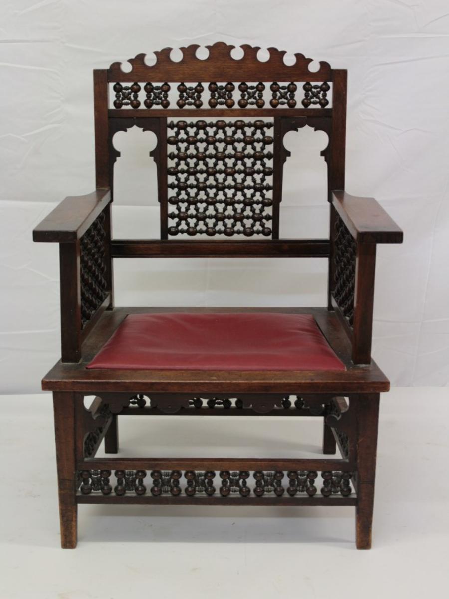Liberty & Co. A Moorish walnut armchair with fretwork cut-outs to the arched top and Mashrabiya turned details throughout.
The last two images from: Liberty's Furniture 1875 - 1915. The Birth of British Interior Design by Daryl Bennett.