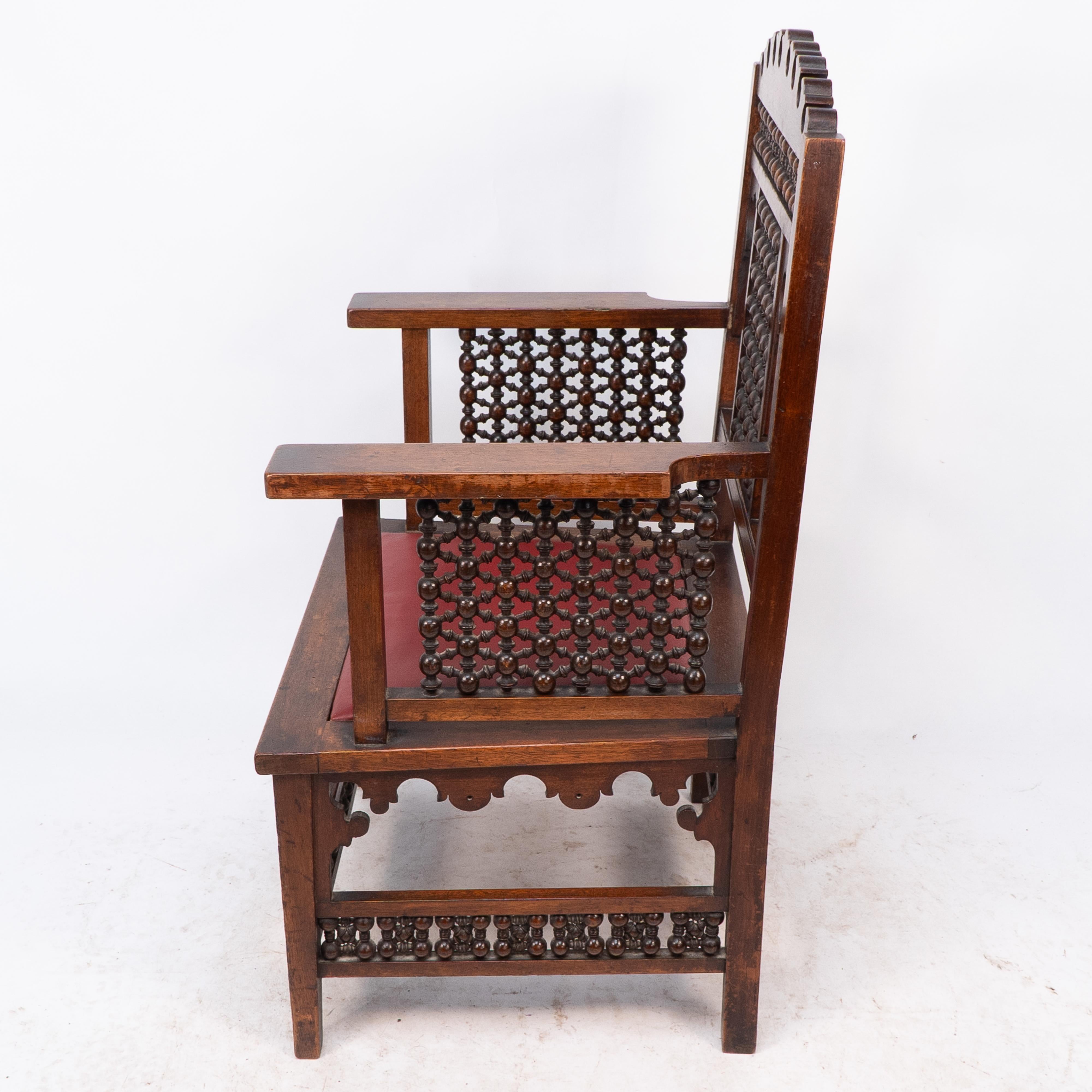 Hand-Crafted Liberty & Co A Moorish walnut armchair with Mashrabiya turned details throughout For Sale