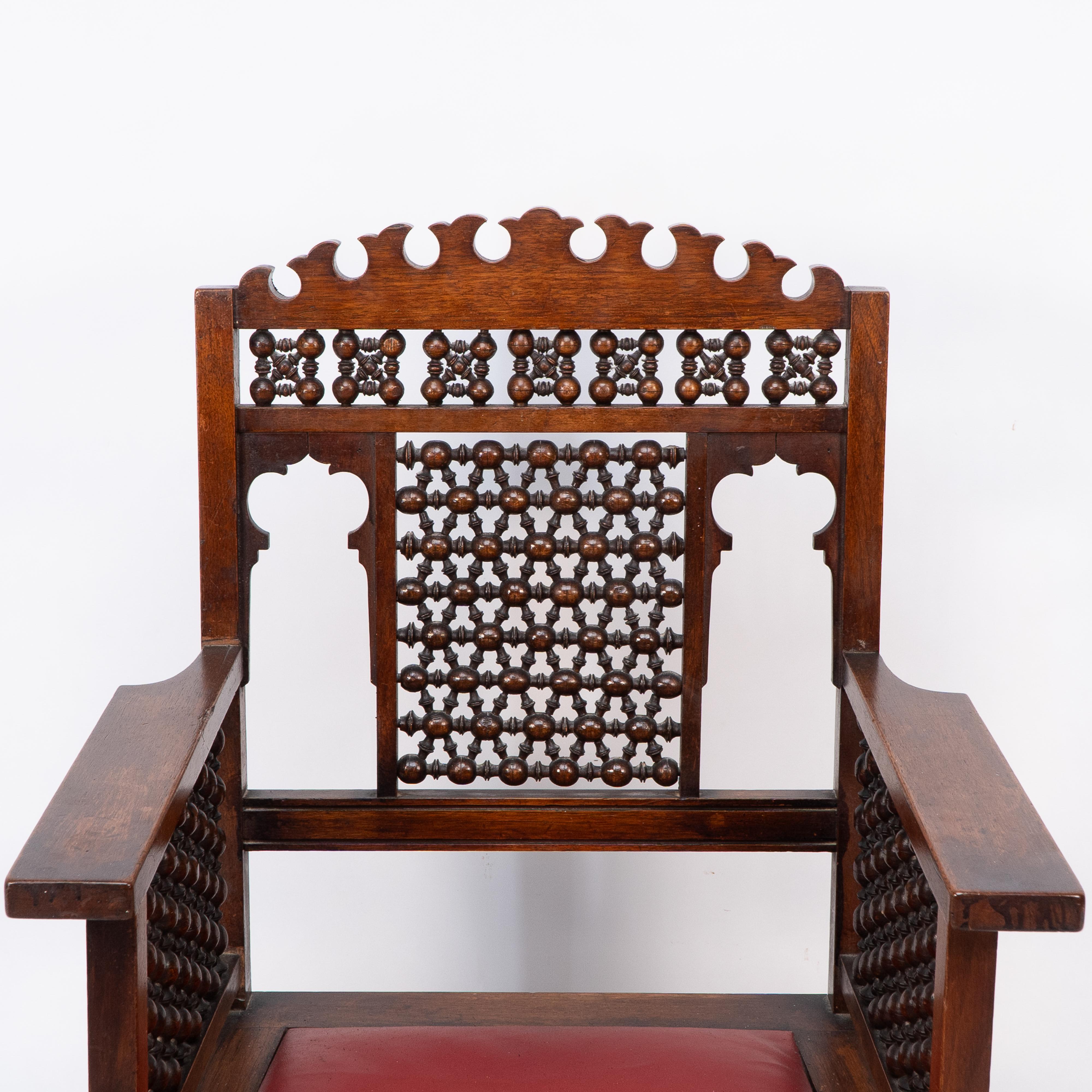 Liberty & Co A Moorish walnut armchair with Mashrabiya turned details throughout In Good Condition For Sale In London, GB