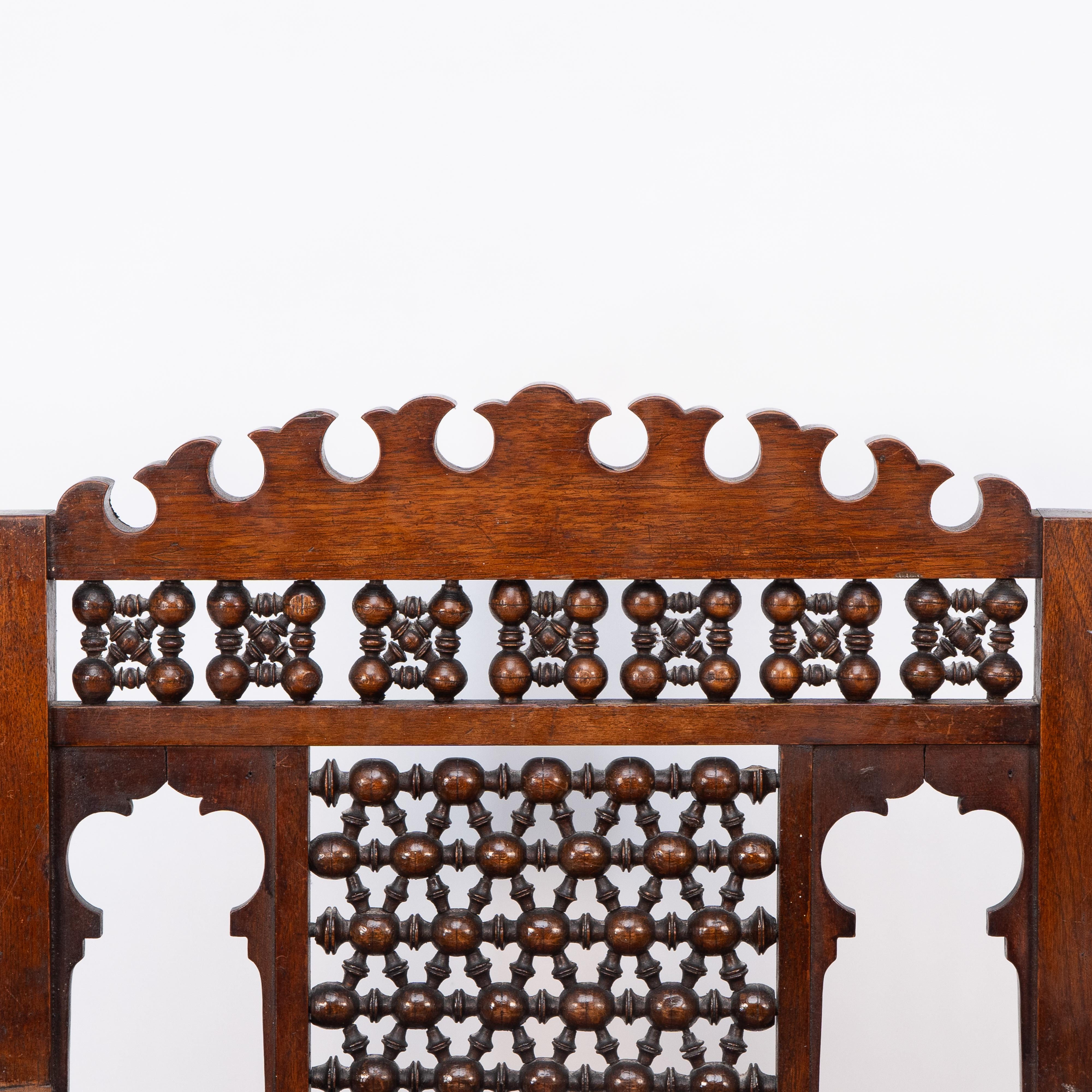 Late 19th Century Liberty & Co A Moorish walnut armchair with Mashrabiya turned details throughout For Sale