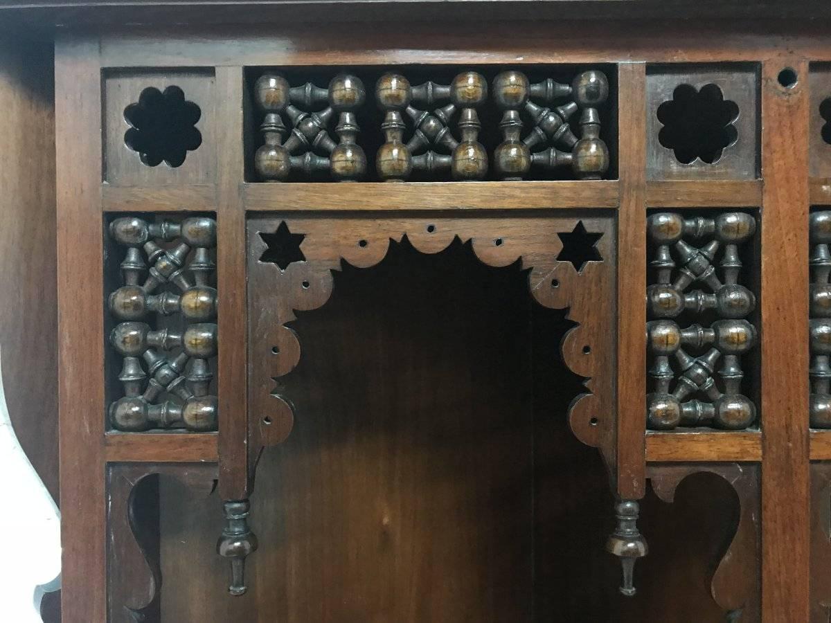 English Liberty & Co. a Moorish Walnut Corner Cupboard with Musharabieh Turned Details