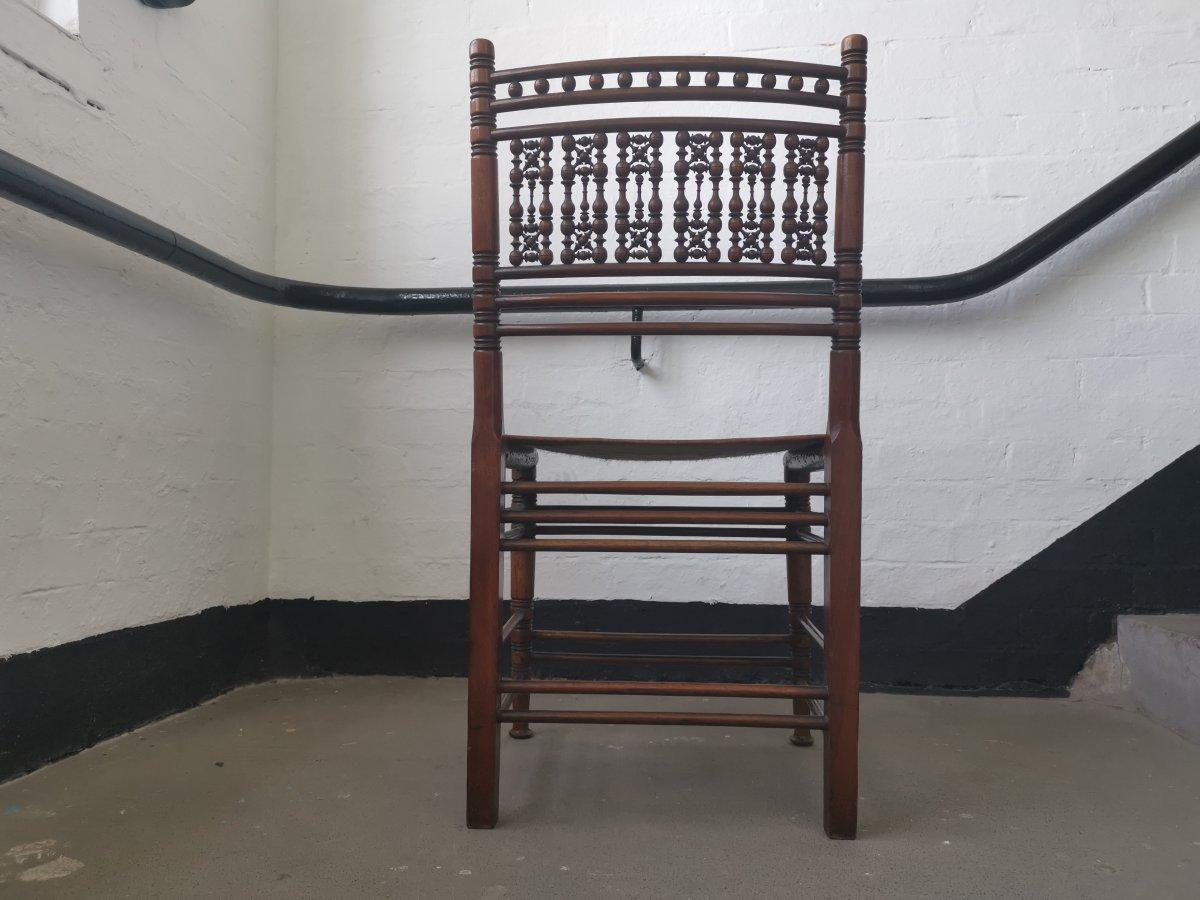 Liberty & Co. A Moorish Walnut Side Chair with Thebes Style Slung Leather Seat In Good Condition In London, GB