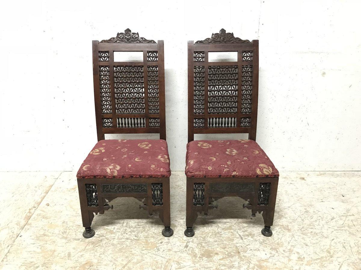 Liberty & Co. a pair of Moorish side chairs with stylised floral carvings to the top and moucharabieh turnings to the sweeping backs and below the seats to the front and to the sides and Egyptian Thebes style turned pad feet.