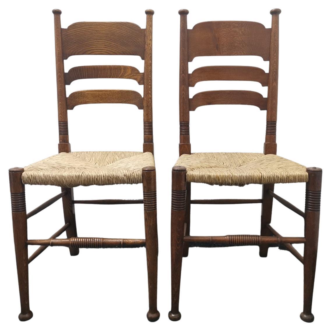Liberty & Co. a Pair of William Birch Arts & Crafts Oak Rush Seat Dining Chairs