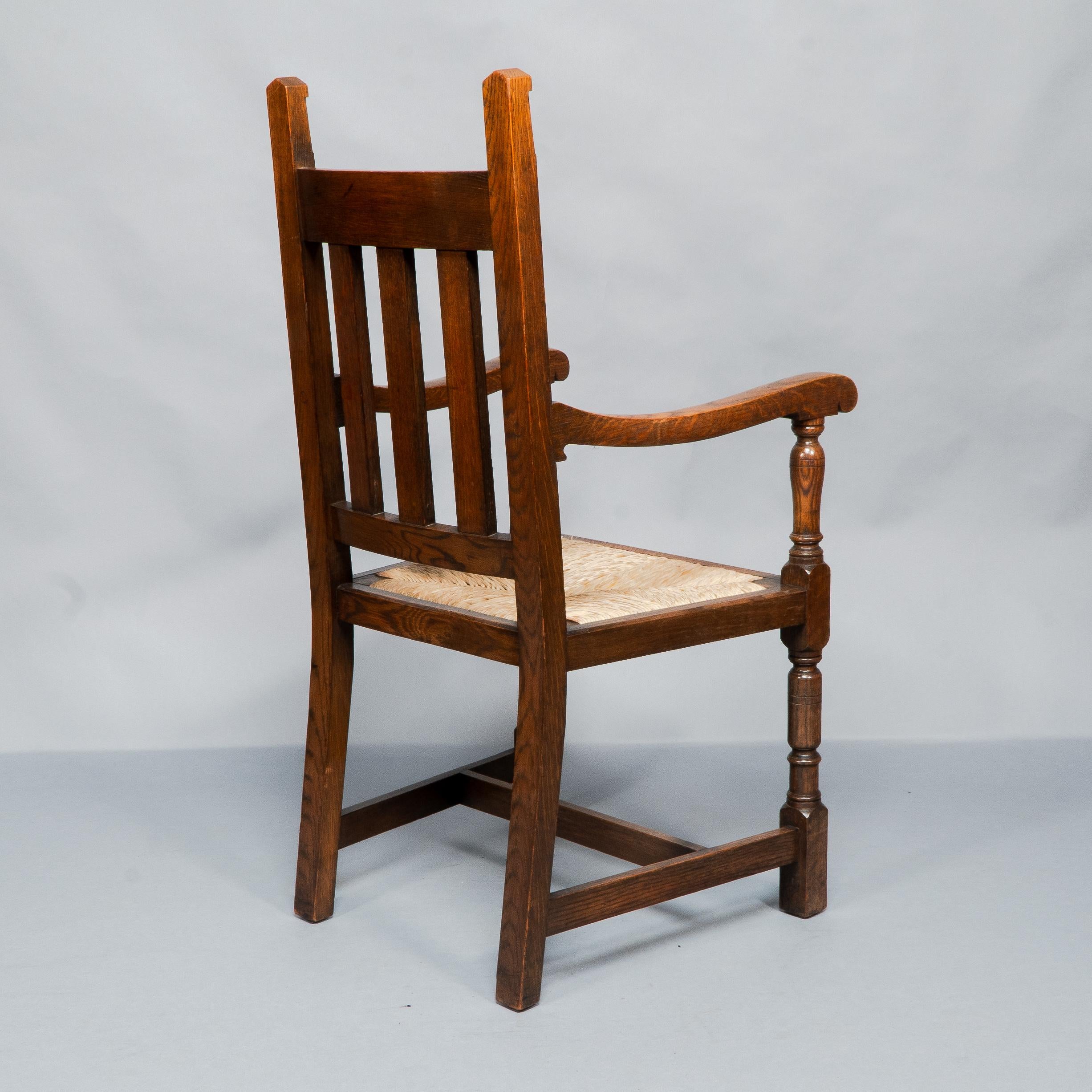 Liberty & Co. A Set of Six Arts & Crafts Oak Arrowhead Rush Seat Dining Chairs. For Sale 12