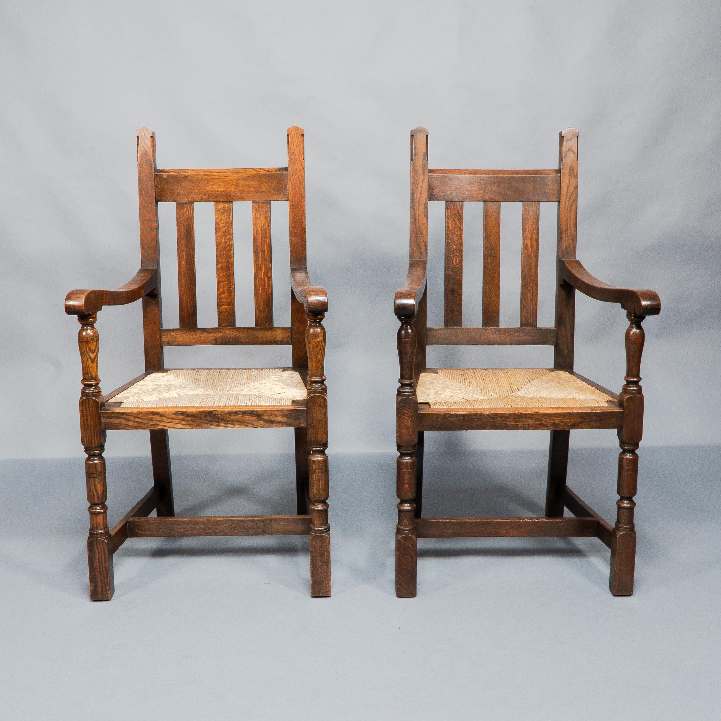 English Liberty & Co. A Set of Six Arts & Crafts Oak Arrowhead Rush Seat Dining Chairs. For Sale