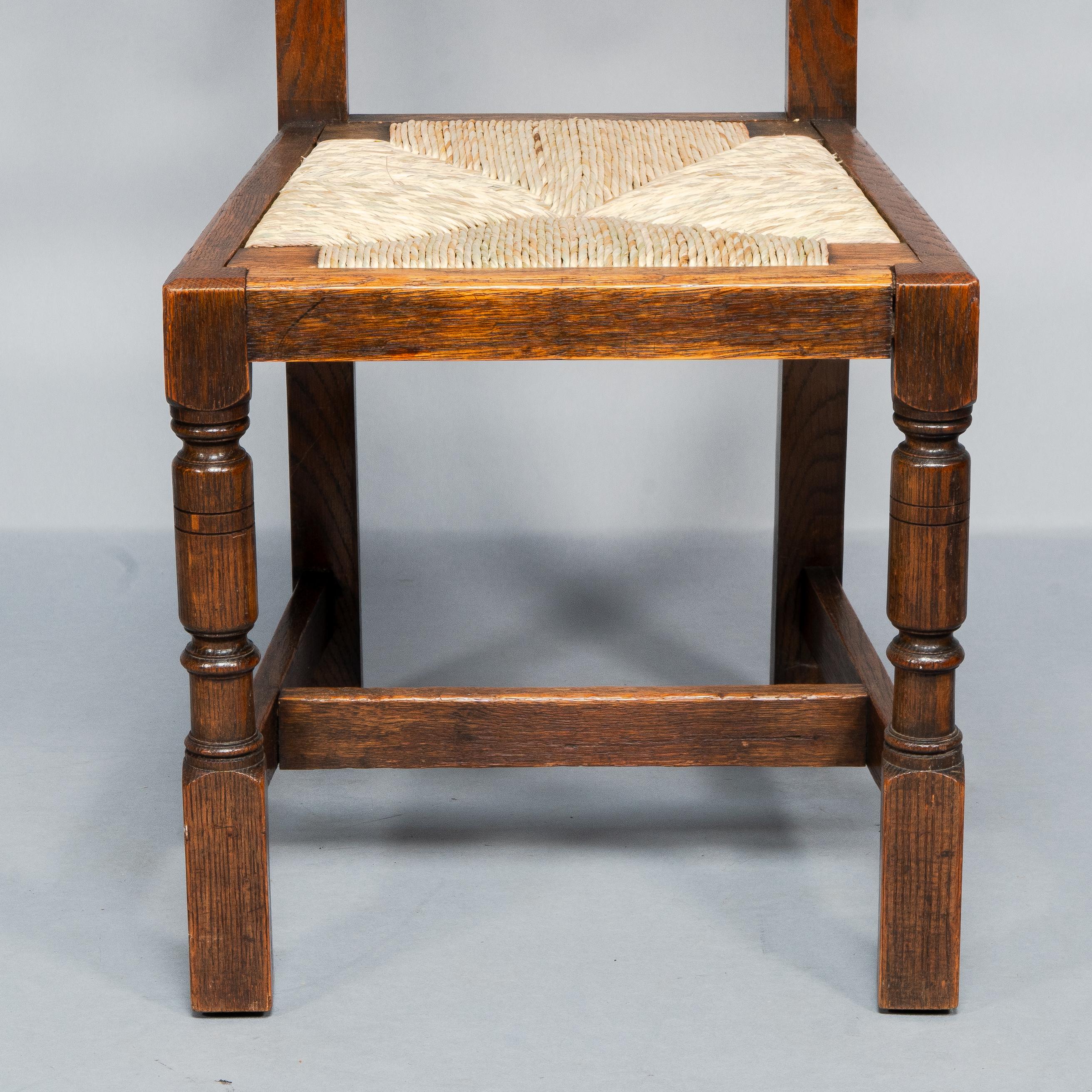 Liberty & Co. A Set of Six Arts & Crafts Oak Arrowhead Rush Seat Dining Chairs. For Sale 6
