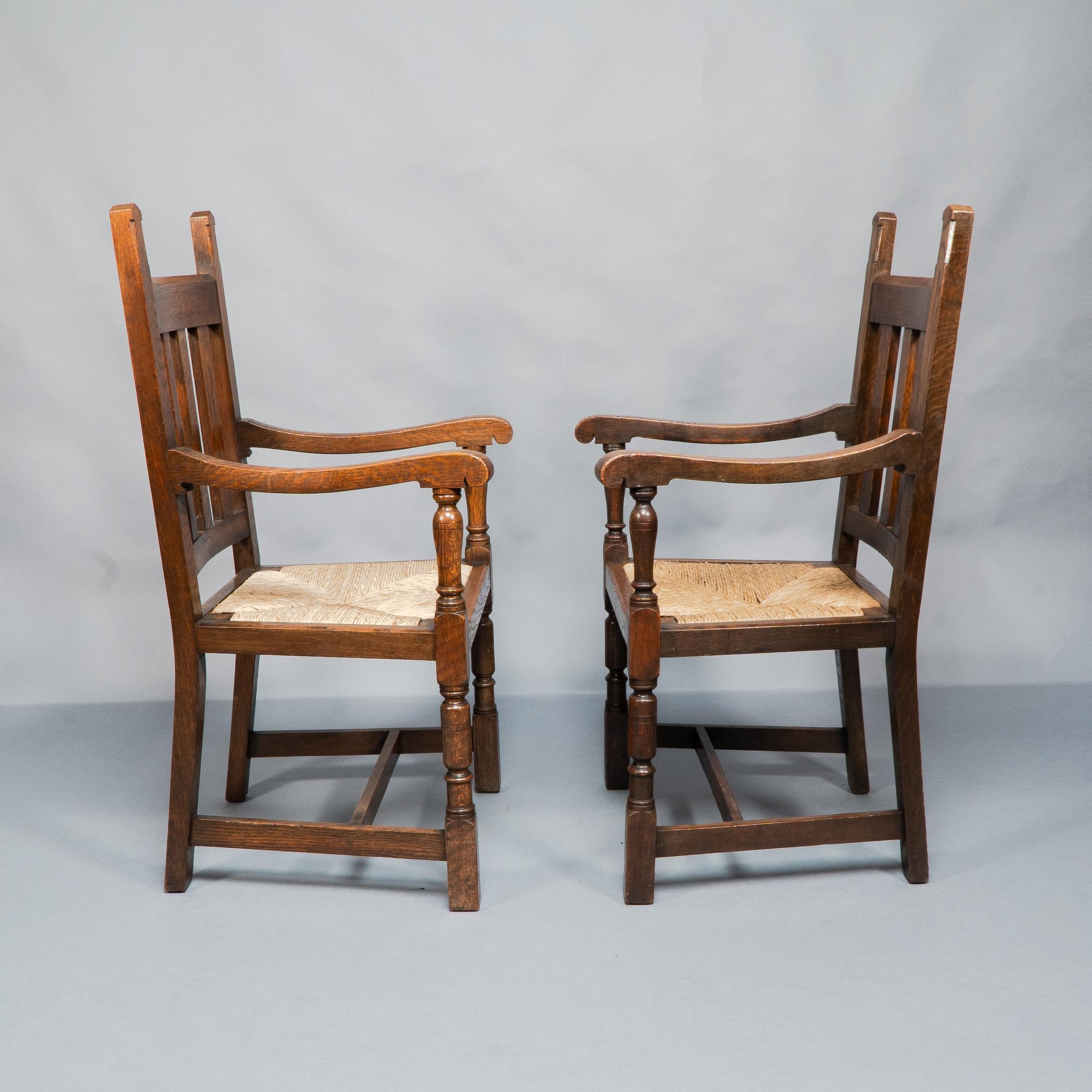 Hand-Crafted Liberty & Co. A Set of Six Arts & Crafts Oak Arrowhead Rush Seat Dining Chairs. For Sale