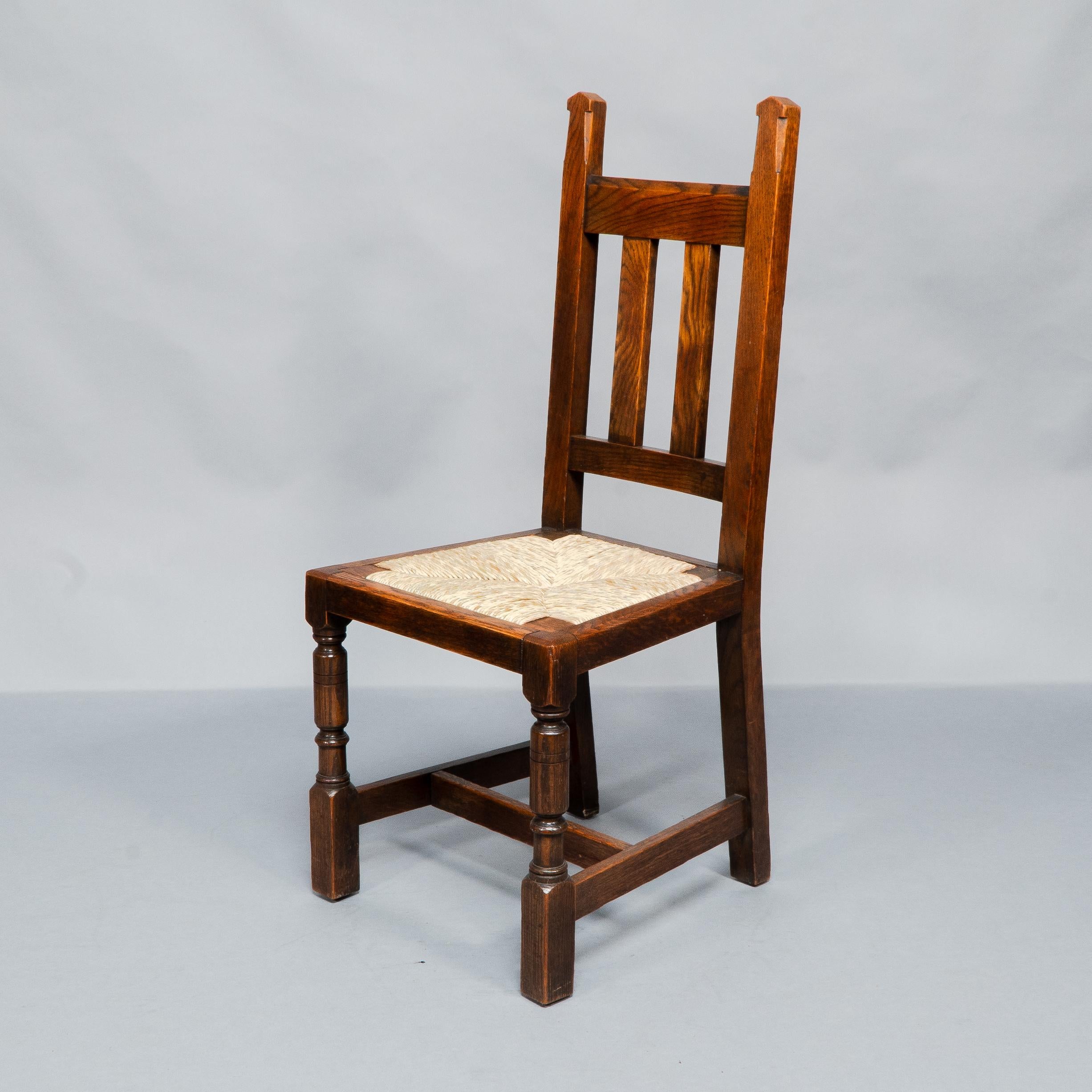 Late 19th Century Liberty & Co. A Set of Six Arts & Crafts Oak Arrowhead Rush Seat Dining Chairs. For Sale