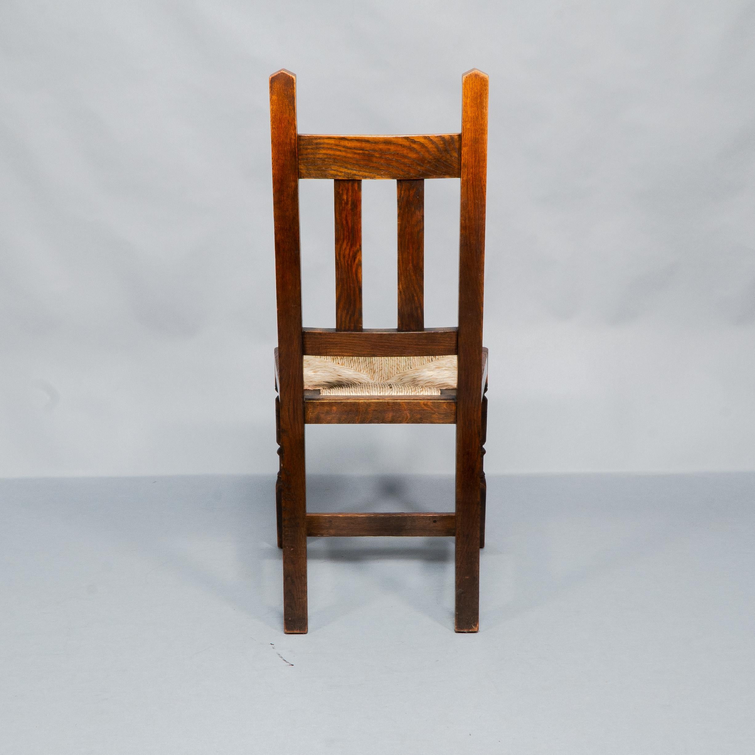 Liberty & Co. A Set of Six Arts & Crafts Oak Arrowhead Rush Seat Dining Chairs. For Sale 2
